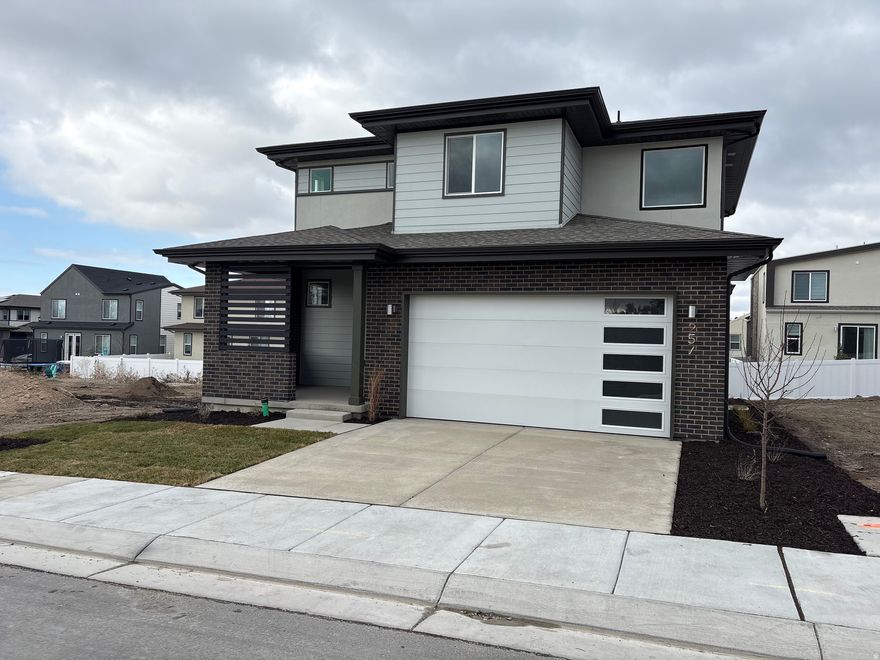 Garbett Homes is offering buyers up to 6% on select move-in-ready homes. This incentive is for a very limited time-please call for details.  Step into this brand new, never-lived-in home at The Mill-just waiting for your Christmas tree and the scent of fresh cookies baking in your never-used appliances. The kitchen features fresh white cabinetry, sleek quartz countertops, and durable modern flooring that blends style with function.  Front and back yard landscaping are included, making move-in day effortless.  Life at The Mill offers more than just a home-it's a connected community with a BBQ patio, neighborhood playground, and quick access to dining, shopping, and Real Salt Lake games. Commuting is easy with close proximity to I-15, I-215, and the Historic Sandy TRAX Station, while nearby canyons offer year-round outdoor adventure.  Inside, expansive solar-E windows fill the home with natural light. Built with comfort and efficiency in mind, this home includes advanced insulation, an energy recirculation system, and a private EV charging outlet. Localscaped yards ensure low-maintenance beauty all year long.  Enjoy the peace of mind that comes with a full builder warranty, plus all the benefits of owning a brand new home-never-used systems, clean air quality, energy savings, and modern construction from day one.  Schedule your tour today and experience how extraordinary everyday living can be at The Mill.