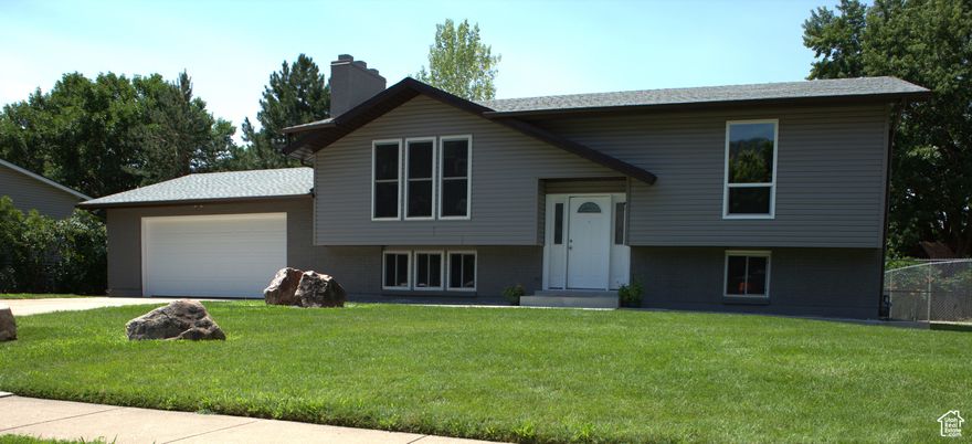 Beautiful well maintained approximately 1,900 square foot family home. This home is truly move in ready! This home has a large, covered deck attached to kitchen, this home has a basement kitchen, and the basement could be easily converted into separate family living quarters, the home has a separate entry into basement. Newly remodeled upstairs kitchen with granite countertops, new hardwood floors throughout upstairs, including stairway to basement 2024, the home has no carpet only tile, hardwood, and epoxy flooring. Newly remodeled 1.75 basement bathroom with marble shower 2025. new lighting though out home 2025, professionally painted inside and out 2025. A well-built sturdy brick home, a two-car attached garage, extensive landscaping 2025, new shingles 2023, new windows 2025, new Central Air Unit 2023, new electrical panel 2025, new dish washer 2025, new garage door 2025, new rain gutters 2025, extensive cement work to include new front sidewalks and front door porch, new back entry cement garage door stairway 2025. A peaceful neighborhood, very close to churches, and Green Acres Elementary. This home has a gorgeous view of nearby mountains. The home is located very close to hiking and biking trails, easy access to North Ogden divide. Enjoy skiing, at Power Mountain, Snowbasin, and Nordic Valley resorts. The home has a large, fenced back yard with locking gates. This home has a fireplace upstairs and a wood burning stove in the basement.