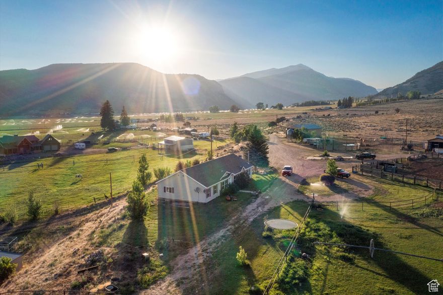 Property is in the process of being subdivided. Postcard-perfect views from every angle set the stage for this hidden equestrian paradise, nestled at the end of a quiet dead-end road in Hanna, Utah, just one hour from Heber. Spanning 41.32 acres, this turnkey horse property is built for both function and serenity. With 30 valuable water shares, the land is well-equipped to support irrigated pasture, hay production, and all your livestock and equine needs-providing both abundance and sustainability for ranch life. The property borders open land with access to hundreds of miles of trails-ride straight from your barn into vast, scenic country with no need to trailer out. Equestrian facilities include a 120' x 40' all-metal stall barn with eight stalls, a 150' x 80' indoor riding arena for year-round training, and an outdoor arena for riding under open skies. A massive 80' x 40' open-sided hay barn provides generous storage, supported by two additional 60' x 25' open-sided pole barns, a 60' x 25' machine shed, a 12' x 48' lean-to shelter, a woodshed, and a charming chicken coop. The land is a peaceful blend of open pasture and native growth, with wild herbs thriving across the property-a place where nature whispers and horses thrive. The existing home offers comfort and practicality with 4 bedrooms and 2 bathrooms, a spacious layout that includes two family rooms anchored by a wood-burning stove. A large pantry, abundant cupboards, and generous closet space throughout make daily living effortless. Whether you live in the current home or build your dream retreat overlooking the valley, this is a rare opportunity to settle into a lifestyle rooted in peace, purpose, and the freedom of wide-open spaces. Property may be subdividable in 6 acre pieces , additional due diligence would be needed. Square footage figures and boundary lines are provided as a courtesy estimate only. Buyer is advised to obtain an independent measurement.