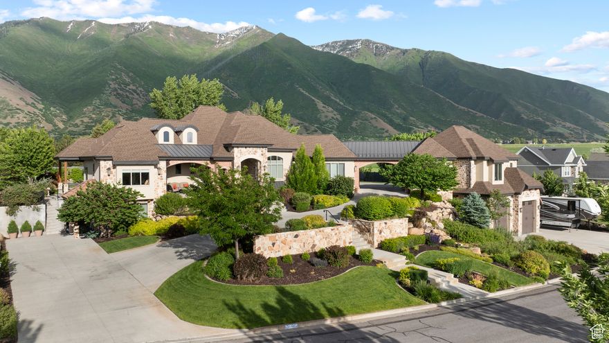 Get ready to be DAZZLED! Let's start with VIEWS! Maple Mountain AND the VALLEY!  One of a kind 'VILLA' oozing with charm and style! There are sooo many details. There is something for everyone in this gorgeous estate. The pictures look stellar, but wait til you see it in person! Stunning foyer, kitchen and great room. Huge walk-in pantry. Primary  bedroom has his/hers closets and you feel as if you are sequestered into your little peaceful haven when you retire here. Ensuite by back main entrance...so easy access for guests or kids. Office with outside entrance with playroom for the kiddos while you work from home.  Great storage! KIVA for the movies! with kitchenette. Workout room! Tall ceilings. *** 9--count them--9 car/boat/rv garages.*** There is no shortage of parking.  The driveway makes a statement and makes accessibility very easy.  Lower garage in detached is 4 tandem. Another detached garage is massively oversized with a temp controlled hunting room/workshop. The backyard boasts a beautiful fire pit, coy pond with lilies, garden boxes, covered patio, open patio, tramp, and more. 3D TOUR: https://my.matterport.com/show/?m=W8LfZEqroKE VIDEO: https://player.vimeo.com/video/1090094611?byline=0&title=0&owner=0&name=0&logos=0&profile=0&profilepicture=0&vimeologo=0&portrait=0
