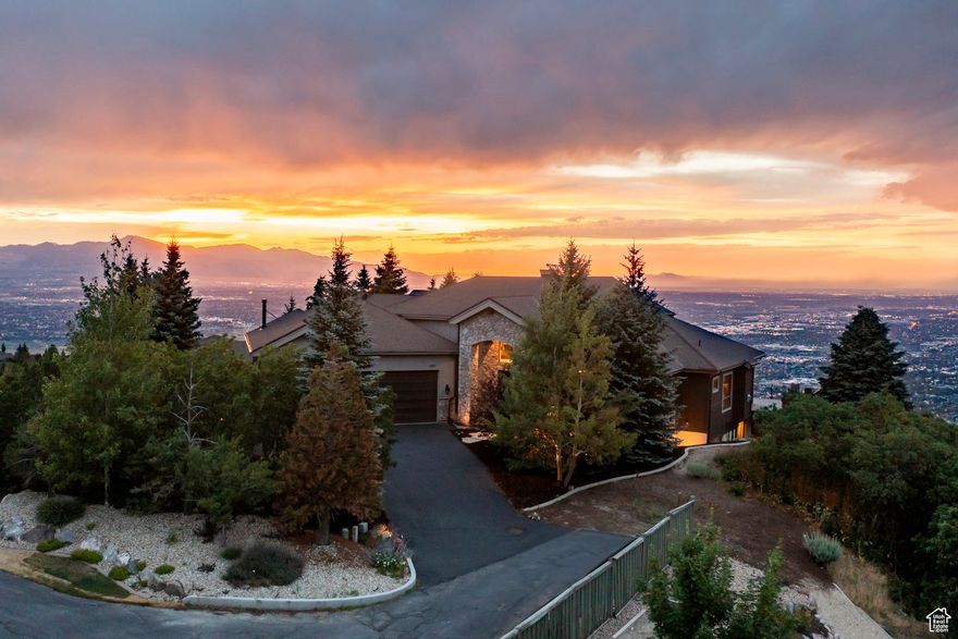 Unobstructed views and the lifestyle you've always dreamed of! Exclusive private lane in SunCrest. 23-ft. vaulted ceiling, floor-to-ceiling windows capture bright orange sunsets, glittering city lights, gorgeous mountains, and billowing clouds. 1,500-square-foot wraparound deck--perfect for entertaining--above the inversion. Comfortable radiant heat and four fireplaces provide cozy winter warmth. Custom open floor plan, gourmet kitchen, and gracious family room. Primary suite spoils you with fireplace, ensuite bathroom, oversized shower, dressing rooms, and laundry room. Two massive home offices connected via bridgeway. Walkout lower level, large living area, 10-ft ceilings, 2nd kitchen, bedrooms with ensuite bathrooms, laundry, 10-seat theater room, plus a must-see 'panic' room with Fort Knox fire-rated door. Storage galore. RV parking with clean-out. Brand new roof and newer AC. Home is in immaculate condition. Near Utah's tech corridor, world-class mountain biking, skiing. Perfect family home or corporate retreat.