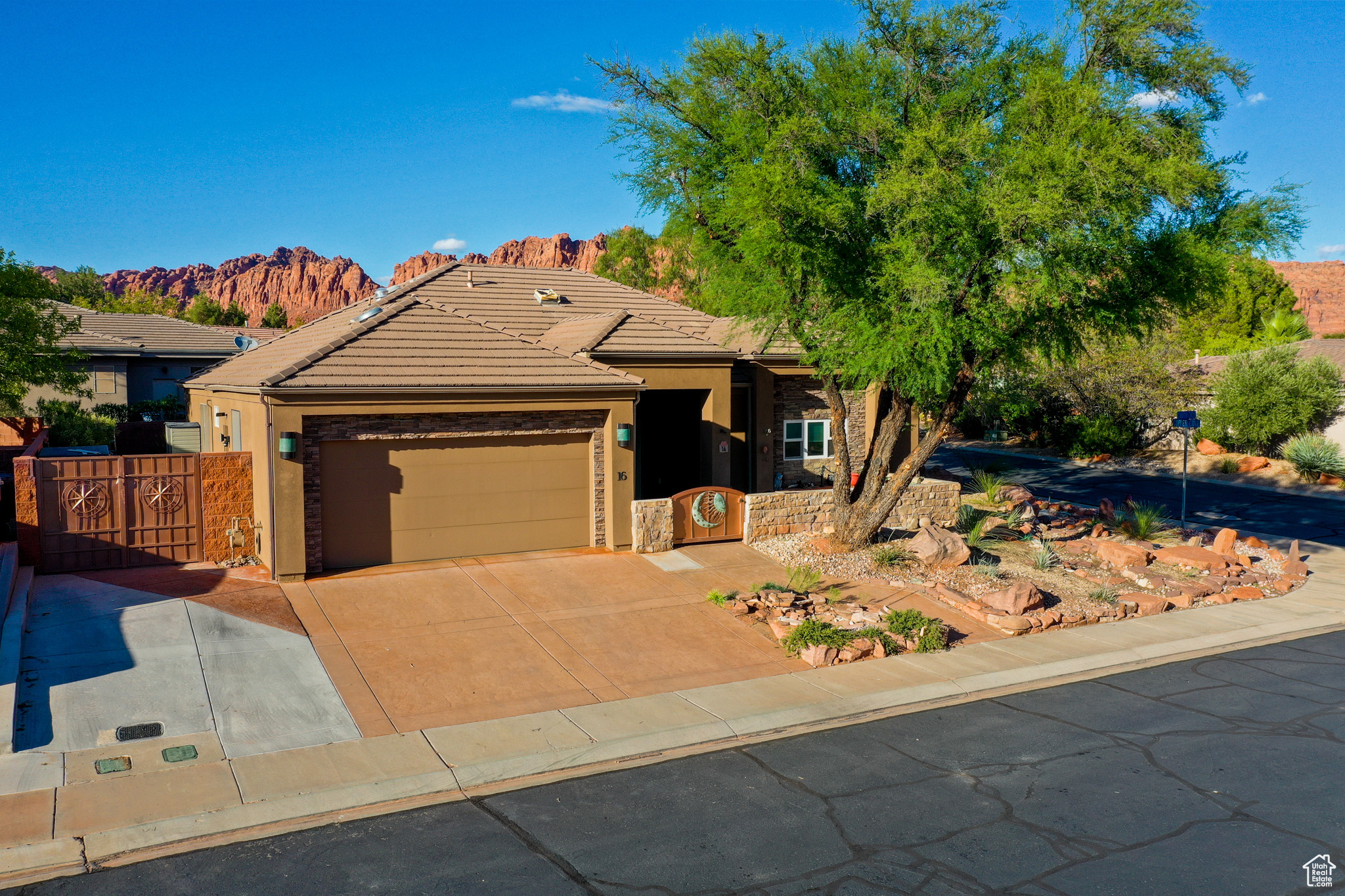 Situated near the majestic Snow Canyon State Park, this BEAUTIFUL SINGLE LEVEL HOME in the desirable COPPER CANYON community awaits your discovery. Enjoy the airy, open floor plan, featuring a modern kitchen with stainless steel appliances and granite countertops, complemented by new tile flooring and a cozy rock fireplace. The home boasts numerous upgrades, detailed in the Property Features & Upgrades sheet available in the documents section. The fully landscaped yard includes a front patio, fenced backyard, and covered patio with striking views of the Palisade Red Mountains. This property offers easy access to Southern Utah's natural splendor, surrounded by dramatic red rock formations and vast desert vistas, creating a tranquil and scenic retreat. Perfect for outdoor enthusiasts, it's steps away from hiking and biking trails leading to Snow Canyon State Park and Tuacahn. The nearby Black Desert Resort, with its world-class golf course less than a mile away, adds to the area's growing appeal. This home is an ideal haven for those seeking a perfect blend of adventure, relaxation, and luxury.
