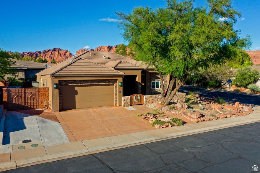 Situated near the majestic Snow Canyon State Park, this BEAUTIFUL SINGLE LEVEL HOME in the desirable COPPER CANYON community awaits your discovery. Enjoy the airy, open floor plan, featuring a modern kitchen with stainless steel appliances and granite countertops, complemented by new tile flooring and a cozy rock fireplace. The home boasts numerous upgrades, detailed in the Property Features & Upgrades sheet available in the documents section. The fully landscaped yard includes a front patio, fenced backyard, and covered patio with striking views of the Palisade Red Mountains. This property offers easy access to Southern Utah's natural splendor, surrounded by dramatic red rock formations and vast desert vistas, creating a tranquil and scenic retreat. Perfect for outdoor enthusiasts, it's steps away from hiking and biking trails leading to Snow Canyon State Park and Tuacahn. The nearby Black Desert Resort, with its world-class golf course less than a mile away, adds to the area's growing appeal. This home is an ideal haven for those seeking a perfect blend of adventure, relaxation, and luxury.