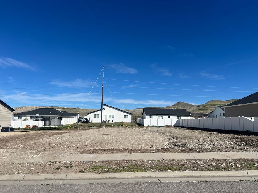 Building lot does have a utility pole on the property with guy-wires. Bring your own builder. Located in Smithfield's east bench. No HOA restrictions. Buyer(s) and buyer(s) agent to verify all information that pertains to building with Smithfield City.