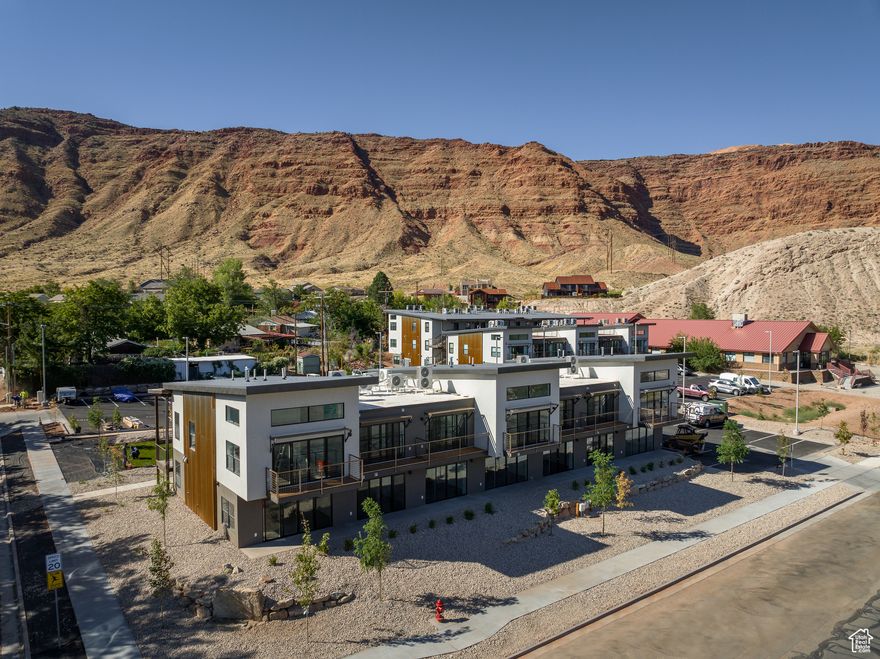 LIVE AND PLAY IN UTAH'S ADVENTURE CAPITAL! Located on the recreational pathway of Kane Creek Boulevard, Kane Creek Condominiums are a short walk to downtown Moab and minutes to all that Moab has to offer. Kane Creek Condominiums sits on over two acres located at the base of the Moab Rim. Each residence offers stunning views of towering red rock cliffs and the expansive Moab Valley with sights of Arches National Park, Swiss Cheese Ridge, and the La Sal Mountains. Only one mile from Moab's City Center, access to town is a short walk or easy bike ride away. Feeling the need for a morning power hike or mountain bike ride? Kane Creek Condominiums is minutes to the Pipe Dream trailhead, Moab Rim, Moonflower Canyon, and more! Each of the residences offer bright windows, modern finishes, wood grain vinyl luxury tile, independent laundry, and a dedicated parking spot, as well as access to dispersed parking and bike racks. Enjoy morning sunrise and evening sunsets from your private patio. Interior photos are of a similar unit.