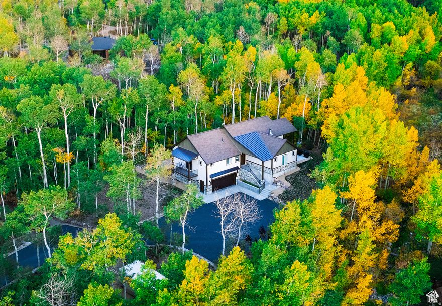 Embrace the ultimate year-round mountain lifestyle where every season brings its own adventure, from hiking, biking, riding ATVs, and wildlife watching in the warmer months to snowmobiling out your own front door into endless terrain in the winter in the glorious Uinta National Forest. Experience luxurious yet adventurous living in the breathtaking winter wonderland of Timber Lakes, a private gated community. This exquisite custom-built mountain retreat is nestled on a secluded, heavily wooded one-acre lot complete with a seasonal tranquil stream, hot tub, and expansive paved driveway with a pickleball setup, perfect for entertaining in every season. Inside, the home showcases an open and inviting floor plan designed for gathering, featuring high-end finishes throughout including stunning flooring, a gourmet kitchen with custom cabinetry, double ovens, a gas cooktop, farmhouse sinks, a spacious butler's pantry, quartz countertops, and beautiful tile work. The warm wood-burning fireplace creates the perfect mountain ambiance, while the elegant primary suite features barn doors and a clawfoot soaking tub for a true retreat experience. Additional highlights include an office with accent lighting, a versatile game room with a pool table (or optional bedroom), a home gym, a theater room, an intercom system, security cameras, and abundant storage, all designed for comfort and functionality. Enjoy the ease of single-level living, along with a backup Generac generator and central air for year-round peace of mind. Sold furnished and ready for your immediate enjoyment! Located just 55 minutes from Salt Lake City International Airport and minutes from Heber, Midway, and Park City, this extraordinary mountain haven offers unmatched access to recreation, serenity, and abundant wildlife, making it the perfect full-time residence or luxury escape in every season.