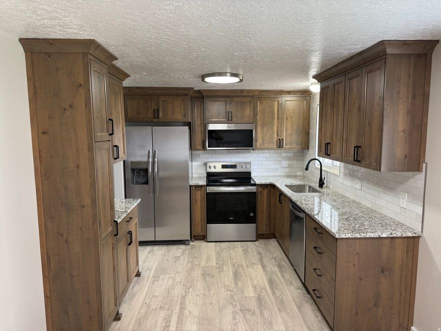 Newly Updated Kitchen with Custom Cabinets,  Granite Countertops, New Appliances.  Fully-Finished, Updated Home.  5 Bedrooms/3 Baths/ and 2 Family Rooms.  Conveniently Located! Updates include:  Painting, Flooring Bathrooms,Kitchen and Deck. Oversized Garage.