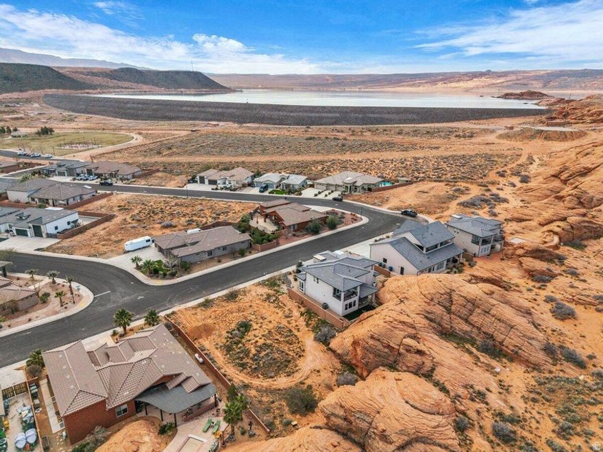 Don't miss the rare opportunity to own one of the last remaining lots backing directly to the breathtaking natural red rocks in Dixie Springs! Wake up to the beauty of Southern Utah's iconic red rock scenery right in your backyard on this spacious, flat lot with endless potential. Bring your own builder and create a custom home perfectly tailored to your vision, with no HOA restrictions. Utilities are conveniently available at the lot, including Dixie Power. Located just seconds from Sand Hollow Reservoir and the sand dunes, and only minutes from shopping, gas stations, and grocery stores, this location offers the ultimate blend of outdoor adventure and everyday convenience. Buyer to verify all information, deemed reliable, however buyer to verify all info including utilities, rental restrictions, and HOA information if applicable.