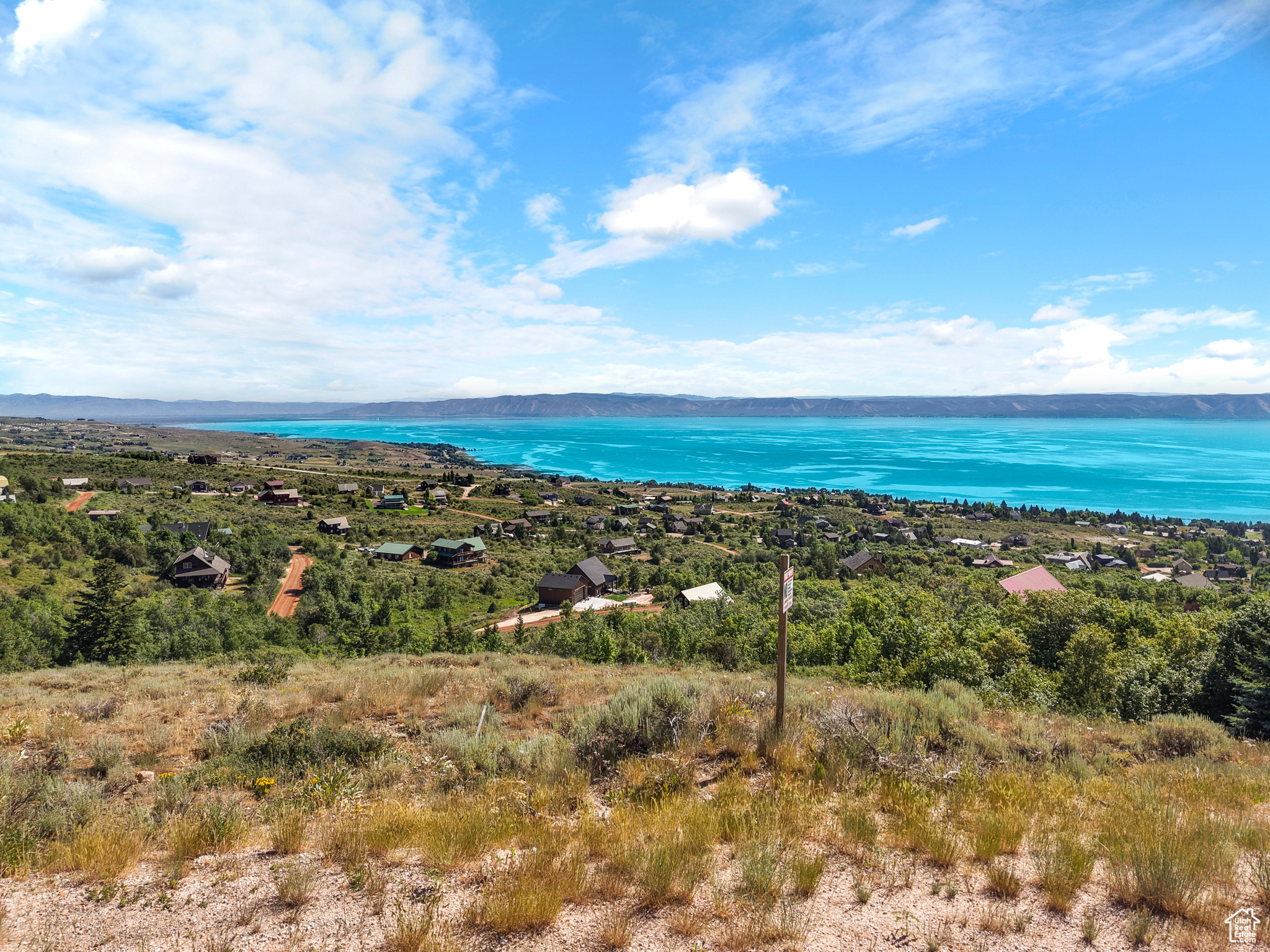 Scenic Views from a Prime Building Lot in the Desirable Bear Lake West Neighborhood. Embrace the tranquility that Bear Lake provides, complete with stunning wildlife and lake vistas. Spend leisurely summer days at your very own Bear Lake Getaway. This property features 1.07 acres of gentle slopes and a south-facing driveway, perfect for your dream getaway.