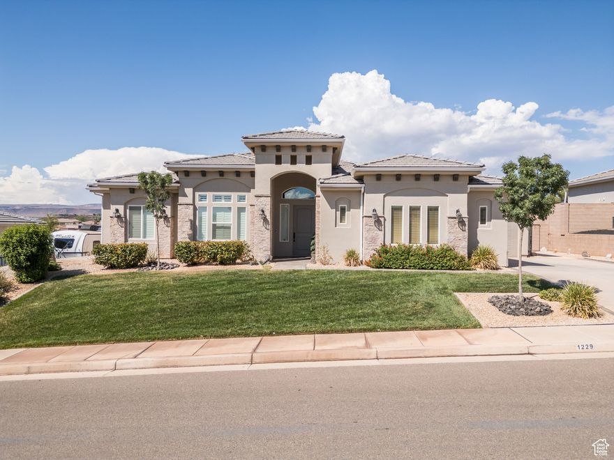 Original Owner, Freshly Painted, 1 Level  home on Dixie Power, breathtaking mountain views, open floor plan, and modern upgrades throughout. Gourmet kitchen features granite countertops, custom backsplash, walk-in pantry, and double ovens with convection. The spacious great room boasts a cozy gas fireplace, surround sound, and built-in storage. Enjoy a luxurious primary suite with soaking tub, separate shower, and large walk-in closet. Additional features include plantation shutters, central vacuum, Honeywell security system, and a flexible 4th bedroom or office. Technology system closet. The 34 car tandem garage fits a long truck and includes shop space, built-in cabinets, keyless entry, and an exterior 50-amp outlet. Outdoors, relax on the covered patio surrounded by fruit trees, grape vines, planter boxes, and a storage shed. Hot water recirc pump, and low HOA reduce your monthly costs. Washington City Shooting Star Park features pickleball courts, open green space, playground, walking trails and plenty of space for friends and family to park.  More walking trails along the Virgin River are nearby at Sullivan Soccer Park. Buyer to verify all information.