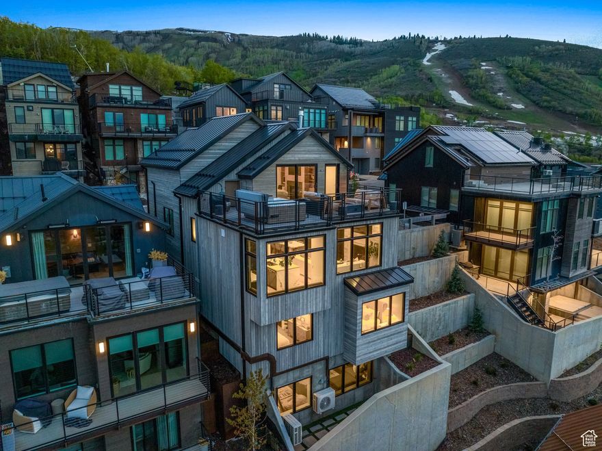 Located in Old Town Park City, King's Crown development, this recently completed five-bedroom, seven-bath residence offers the ultimate ski-in/ski-out mountain retreat. Designed by Kristen Bombeck and built in 2024, the home blends sophisticated design, custom finishes, and luxurious details with a thoughtful floor plan that emphasizes both comfort and privacy. Just steps from the private owner's lounge and lockers at The Tower, the home provides seamless mountain access while offering spacious, inviting interiors. Five en-suite bedrooms are positioned across multiple levels-including a top-floor primary suite with a heated rooftop deck, hot tub, and fireplace-framing views from City Park to Lewis Peak. The main level integrates copper, stone, and wood into a stylish yet warm gathering space, anchored by a chef's kitchen with quartz and marble countertops and top-of-the-line appliances. Natural light floods the interiors, enhanced by carefully curated furnishings, custom built-ins, generous storage, and Lutron automated shades. A lower-level lounge with adjacent bunkroom provides a perfect setting for movies and games, while an elevator ensures easy access to all four levels. Every detail, from flooring to countertops, has been thoughtfully selected to balance beauty and functionality. Beyond the home, four seasons of recreation await: direct ski-in/ski-out access, miles of hiking and biking trails, and proximity to Park City Mountain Resort's base village and the Park City Golf Course-all just a short walk away.