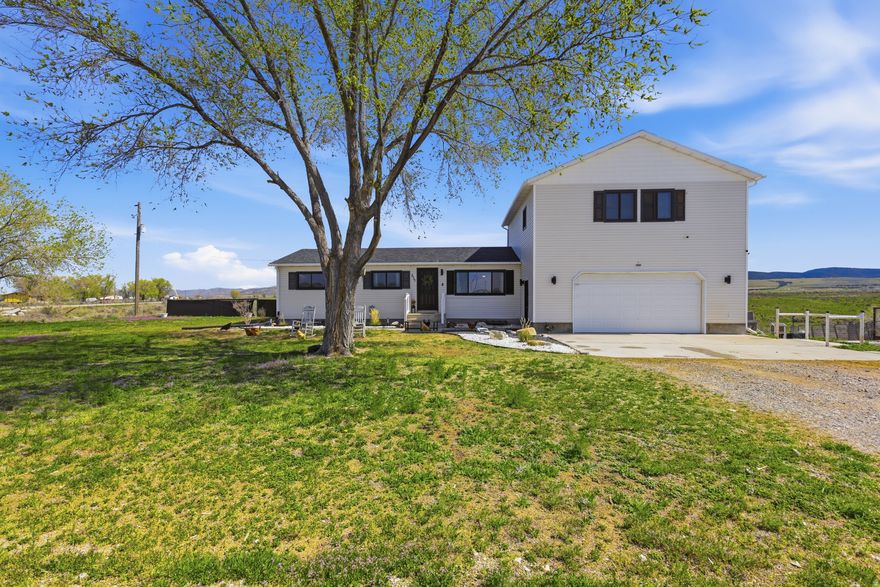 Experience the opportunity for rural living with this 4-acre homestead offering space, flexibility, and hobby farm potential. This rambler-style home features multiple living areas, including family rooms on both the main level and a fully finished walkout basement. The private upper-level primary suite is the perfect retreat. The acreage provides room for a variety of uses - bring your chickens, goats, and horses. Zoned for single-family and agricultural use, the property supports animals, gardening, and the possibility of additional outbuildings. The outbuildings include a 10x12 shed; 4x8 raised chicken coop with 120 square foot run; 8x17 walk in chicken coop; and 8x14 livestock shed. The large attached garage provides plenty of storage for vehicles, tractors, side-by-sides and more. Enjoy the large deck overlooking the property where you can enjoy peaceful evenings and quiet mornings where you can indulge in an atmosphere of complete happiness. Enjoy the country life with no limits, just simply, pure country. Square footage figures are provided as a courtesy estimate only and were obtained from County Records. Buyer is advised to obtain an independent measurement.