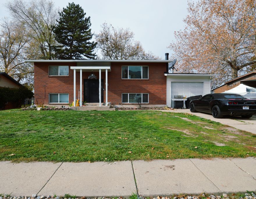 Welcome home to this conveniently located property. Ideally located in a quiet, established neighborhood with easy access to I-15, parks, schools, shopping centers, restaurants & entertainment. This home offers an open main floor layout with great space for entertaining and for the family to gather and relax. Recent updates include updated flooring, newer appliances, large laundry room, refinished kitchen cabinets and a brand new bathroom in basement creating a move-in-ready home! Basement is a walkout and could be turned into an apartment for rental income. The home also comes with refrigerator, washer and dryer. Enjoy a large private backyard, ideal for entertaining, gardening and other outdoor hobbies. This property is a great investment, whether you're a growing family, first-time home buyer, downsizing, or an investor.