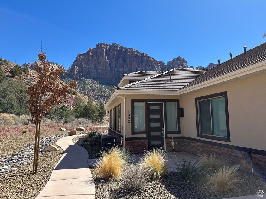 Your Zion Retreat awaits!! Extremely rare opportunity to own, one, two, three or four beautiful, like new condominiums just 1/2 mile from Zion National Park! This is one condo in a four plex property. Buy, 1, 2, 3 or all 4! All four units are the identical layout, with the same features and finishes.  Located in the tranquil Moenave community, in the heart of Springdale, Utah, this home offers stunning, unobstructed 360 degree towering red rock views. With expansive windows and 9' ceilings natural light fills the home, ensuring you're surrounded by breathtaking scenery from every room.  The thoughtfully designed floor plan provides an inviting and spacious living area. The kitchen features a large island, granite countertops, subway tile backsplash, and custom cabinetry with crown molding, glass accents, with above and under-cabinet lighting. Stainless steel appliances, including a gas (propane) range and side-by-side refrigerator with water and ice dispenser, complete the space. Luxury vinyl flooring flows throughout the main living areas, complemented by recessed lighting. Bathrooms feature tile flooring, tile shower surrounds with glass doors, and granite countertops, adding to the home's refined design.  The covered patio off the dining area creates a charming outdoor living space perfect for enjoying your morning coffee and evening cocktails. You simply can not beat the peaceful beauty that is Moenave.  Built with high-quality, energy-efficient features, including 2x6 exterior walls, blown-in insulation (R50 attic / R23-25 walls), Low-E windows, a 95+% efficient furnace, and a tankless water heater, this home offers both comfort and sustainability.  Located at the heart of Springdale, and in walking distance from its shops and restaurants with an abundance of stunning hiking and biking option, this home is the perfect blend of luxury, convenience, and breathtaking, natural beauty. Everything you dreamed your Zion Retreat would be, and more!  ALL furnishings & Appliances INCLUDED! Excellent investment opportunity! The current owners have used one for their family to stay when they visit and have kept the other three rented to excellent tenants for the last couple of years.  The City of Springdale does not allow overnight rentals. Long term rentals are allowed at a minimum of 60 days.  All information provided as a courtesy. Buyer to verify all.