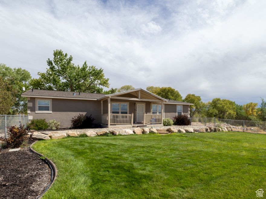 Welcome to this spacious 3 bedroom, 2 bath manufactured home on a permanent foundation, situated on 2.50 acres in the Cedarview/Neola area with plenty of room to spread out. The open floor plan offers comfortable living and entertaining space, featuring an oversized primary suite with a large bathroom and closet. A dedicated office provides flexibility to function as a 4th bedroom. The home is on a well that has a reverse osmosis system, water softener, and filters. The exterior of the home has been updated with new paint. New blinds have been installed on the front windows.  The kitchen, dining, and living area are open with large windows that let in natural light highlighting the great gathering areas. The beautiful decking is a great place to enjoy some privacy and view the wildlife and mountain views. In addition to the main home, the property includes a detached cabin that could serve as a rental or ADU, giving you income potential or space for guests. The garage door has recently been replaced and provides additional parking. The cabin will need a new septic, plumbing, and additional repairs to make it livable. It has power and water. Cabin is sold as-is. The land features 3 apple trees, 1 pear, and 1 apricot tree including a pump house that can also be used as a storage shed. There is RV parking, and a road that extends around the perimeter of the property. So many possibilities! Contact agent to schedule. Square footage figures are provided as a courtesy estimate only and were obtained from county records. Buyer is advised to obtain an independent measurement.