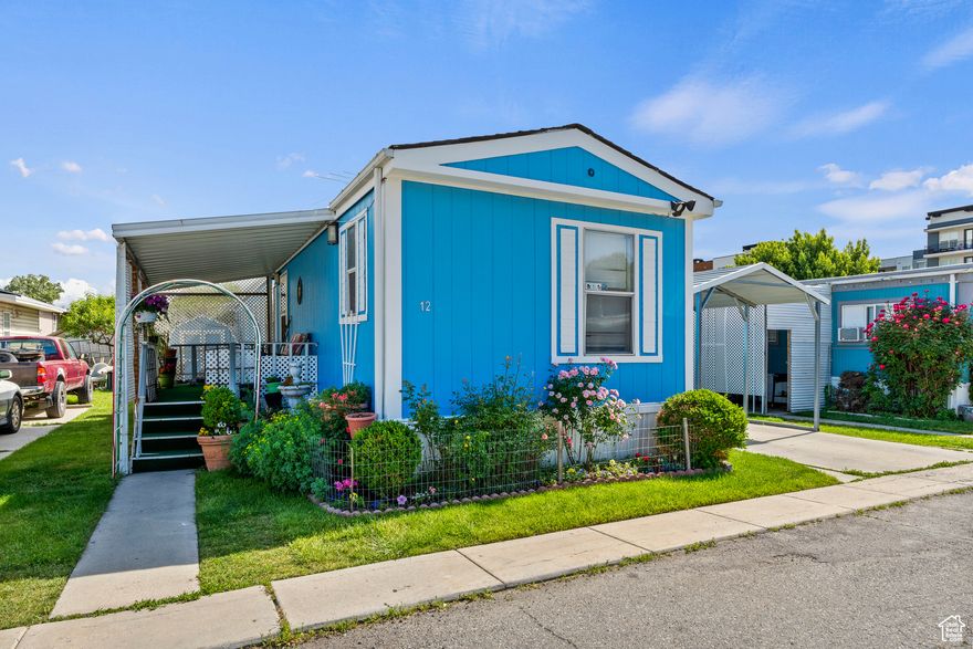 Beautifully maintained 3-bedroom, 2-bathroom mobile home that offers both comfort and functionality. Step inside to find a bright and inviting white kitchen, complete with ample cupboard and countertop space, an island with bar seating, and an open layout ideal for everyday living and entertaining. The spacious living areas are complemented by a dedicated laundry room with built-in cabinets for added convenience. Recently painted and featuring a roof that's only five years old, this home is move-in ready with updates that give peace of mind. Outside, enjoy relaxing on the large covered porch or take advantage of the 2-car covered carport that provides ample parking. A matching shed offers additional storage and blends seamlessly with the home's exterior. This move-in-ready home combines charm, practicality, and low-maintenance living in one perfect package. Square footage figures are provided as a courtesy estimate only. Buyer is advised to obtain an independent measurement.