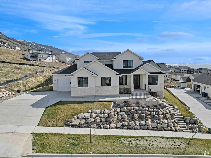 NEW FENCING BEING INSTALLED FOR MORE PRIVACY. Perched high on the coveted Providence Bench, this home is a perfect blend of luxury, functionality, and sheer wow factor! With over $30K invested in stunning landscape rock, the curb appeal alone will make you want this home-and that's before you even step inside.Lots of natural light, transom windows, 9 foot main floor ceilings and 2 Story open to above great room with fireplace, large kitchen and a expansive walk-in pantry. A  separate office nook just off the kitchen offers the perfect spot for working from home, organizing life's details, or even transforming into a butler's pantry for the ultimate hosting convenience. Master suite with big windows seperate tub/shower, double sinks and a closet the size of a bedroom featuring a built-in center island with a countertop and drawers-perfect for extra storage or effortless packing. Newely finished basement with a kitchenette, workout room or den, and play room besides 2 bedrooms &large family room.  Epoxy flooring in the garage that can fit 4 cars. This home is a rare find-thoughtfully designed, perfectly maintained, and move-in ready. Don't miss your chance to own one of the most stunning homes in Providence! Buyer to verify all information.