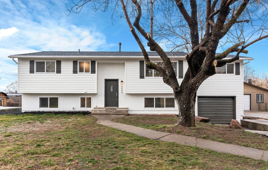 Extensively remodeled, this Roy home offers nearly 3,500 sq. ft. of high-end finishes, exceptional space, and rare versatility in an established neighborhood just minutes from shopping, freeway access, and Hill Air Force Base. The main level features just under 2,000 sq. ft. of open, light-filled living space designed for both entertaining and everyday comfort. The fully remodeled kitchen showcases custom cabinetry, quartz countertops, and updated fixtures, flowing seamlessly into spacious dining and living areas framed by large windows. A sunroom provides excellent additional flexible space. The primary suite offers a private retreat with a walk-in closet and a spa-inspired bath featuring a custom tile shower with Euro glass and a freestanding soaking tub. Two additional generously sized bedrooms, an updated full bath, and main-level laundry allow for convenient single-level living, if desired. Downstairs includes an updated 789 sq. ft. accessory apartment with a private entrance, kitchen, laundry, two bedrooms, and a full bath-ideal for extended family or potential rental income (estimated at $1,500+ per month) to offset the majority of your mortgage. The remaining basement space offers a large family room and a versatile flex room with garage access. Major updates include a new roof, new windows, new flooring, new paint, updated plumbing and electrical fixtures, new cabinetry, quartz countertops, and trim throughout. Originally built in 1977, the home now lives and feels like new.An extra-deep attached garage and ample additional parking complete the property. With its income potential to help offset the monthly mortgage payment, this home offers a rare opportunity for both comfort and affordability. It delivers an exceptional combination of size, condition, versatility, and built-in income potential-truly one of a kind.