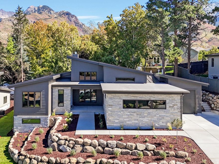 Tucked away in one of Sandy's most sought-after neighborhoods, this beautifully designed rambler-style home offers timeless finishes and thoughtful functionality throughout. With 4 bedrooms and 4.5 bathrooms, this home provides comfortable main-level living with plenty of additional space for entertaining and everyday life. The main floor features expansive windows and vaulted ceilings that fill the home with natural light. An open-concept layout seamlessly connects the gourmet kitchen, dining area, and great room, creating an inviting space perfect for gatherings or quiet evenings at home. A dedicated main-level office provides an ideal space for working from home or quiet study. The spacious primary suite on the main level serves as a peaceful retreat, complete with a luxurious ensuite bath and walk-in closet. The fully finished lower level expands the living space with a large family room, additional bedrooms and bathrooms, and flexible areas that can adapt to a variety of needs. Set on a quiet cul-de-sac in a beautiful Sandy setting, this home offers privacy while remaining close to everything - parks, top-rated schools, outdoor recreation, and the Wasatch Front's world-class skiing and biking.