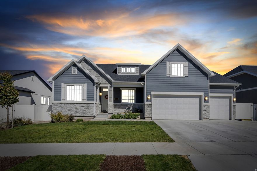 Nestled against the stunning Oquirrh Mountains in Lake Point, Utah, this exceptional rambler-style home offers space, flexibility, and breathtaking comfort-just minutes from I-80 and under 30 minutes from downtown Salt Lake City. With over 5,100 square feet, 7 bedrooms, and 5.5 bathrooms, this home is perfectly suited for large households, multi-generational living, or income potential with a fully equipped mother-in-law suite.  The light-filled main level features 9-foot ceilings and oversized windows throughout. At the heart of the home is a gourmet kitchen designed for both beauty and function, showcasing an extra-large island, marble-style quartz countertops, custom tile backsplash, crisp white cabinetry, double ovens, range with hood, dishwasher, and a spacious pantry. A sunroom-style dining area wrapped in windows creates a bright and inviting space for everyday living and entertaining.  The expansive great room impresses with vaulted ceilings, a gas fireplace with custom tile and stonework, built-in bookshelves, and an elegant chandelier. Above, a charming loft overlooks the space-perfect as a reading nook or quiet retreat.  This thoughtfully designed home offers three master suites, each with walk-in closets and en suite bathrooms. The main-floor primary suite is a true sanctuary, featuring a sitting area surrounded by windows, tray ceiling, dual walk-in closets, and a spa-inspired bath with double vanities and a walk-in shower. The upstairs loft master provides a cozy, private escape, while the basement master-part of the mother-in-law suite-includes a sitting area and a beautifully appointed bath with double sinks, soaking tub, walk-in shower, marble tile surrounds, and a dedicated linen closet.  The mother-in-law suite also includes a large family room, dining area, and kitchenette with sink, ample cabinetry, and a full-size refrigerator. Additional unfinished basement space offers excellent potential for a home gym, office, or storage. Brand-new carpet throughout the home provides a fresh, move-in-ready feel.  Designed with both people and pets in mind, the home features thoughtful dog-friendly upgrades including a magnetic dog door, custom dog deck with stairs, fenced dog run, and a charming Dutch door in the main-floor primary suite. Outdoor living is equally impressive with a covered porch, spacious patio, built-in basketball standard, fire pit area, and in-ground trampoline, perfect for entertaining and active lifestyles. A 3-car garage with built-in shelving completes the property.