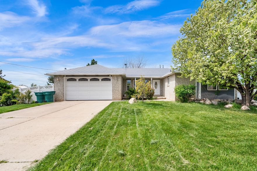 *** OPEN HOUSE Saturday 11th 11:00am - 1:00pm ***This spacious 5 - bedroom, 3 - bath home offers plenty of room to spread out and enjoy. You'll love the fresh updates, including brand new carpet and fresh interior paint on the main floor that give the home a clean, move-in-ready feel. The beautifully updated kitchen features newer appliances, creating a modern and functional space for everyday living and entertaining. Refrigerator, washer, and dryer are all included for added convenience.  The finished basement provides additional living space, perfect for family gatherings, guests, or a home office. Step outside to a stunning custom covered deck with Trex decking, ideal for relaxing or hosting gatherings. The fully fenced yard offers privacy and space to enjoy, complete with a Bullfrog hot tub included.  With generous bedrooms, flexible living areas, and thoughtful upgrades throughout, this home combines comfort, functionality, and outdoor enjoyment. Conveniently located with easy freeway access and close to restaurants, shopping, and other great amenities.  Call, text, or email for a personal showing.