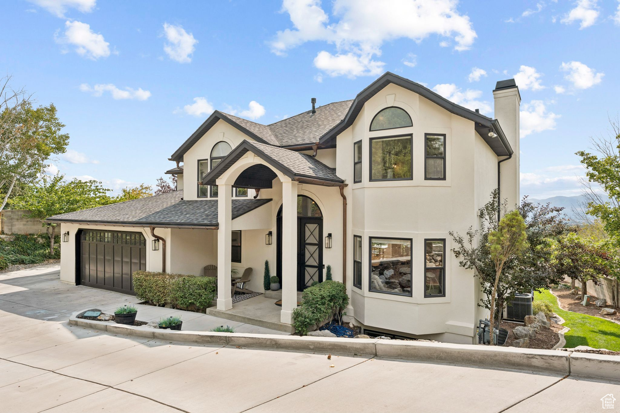 WOW! What a find! Santa won't be landing on this nearly new heated driveway! Do nothing, the snow and ice just melts! Home is nestled on Salt Lake City's east bench, this fully remodeled home offers elevated luxury living with stunning 180-degree valley, mountain and city views. Light, bright and beautiful this two-story home sits on a flat 0.45-acre lot backing the Bonneville Trail also providing unbeatable access to hiking, biking, nature and stunning sunsets. Add to it the beautiful curb appeal, this home really pops with the copper gutters, Ironworks front door and a tree filled private lot. Inside be wowed by the vaulted ceilings and the high end finishes. Enjoy this fully remodeled home including beautiful hardwood floors, a chef's kitchen with top-of-the-line appliances, large windows with views for miles. Open and comfortable great room with views for miles. Gas fireplace makes for warmth and ambiance. Covered deck is great for BBQ'ing and relaxing. Large primary suit with private balcony and a spa-inspired primary bathroom with a steam shower and multiple shower heads. Large walk out basement with wet bar, family room and storage closets. Entertain year-round on the covered deck, unwind in the hot tub and watch your favorite team on the outdoor TV, or watch the sunset over the valley. The 4-car garage with level 2 electric charger and the heated driveway ensure comfort and convenience. With no backyard neighbors, a built-in trampoline, playground and expansive flat grassy yard, this home is perfect for those seeking space, luxury, and lifestyle. Don't wait, come and see!