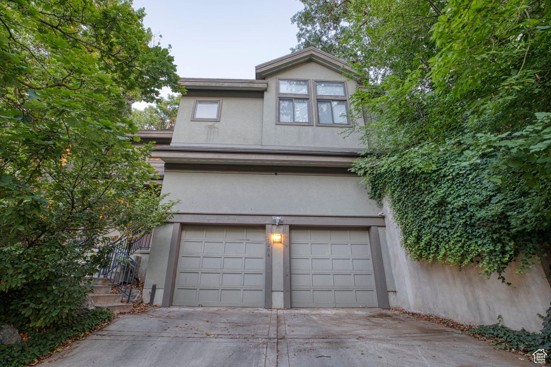 This home is a unique urban oasis in Historic Gilmer Park with mature trees surrounding the property that are visible out of every window. The vaulted ceilings and skylights provide gorgeous natural light. This contemporary home features an open floor plan, and a spacious kitchen with updated appliances, and gas fireplaces. The primary suite has large walk in closets and access to a private, fully shaded, wrap around deck. This two story home has living space on both levels and a two car garage. Washer and dryer are on the main level and included. It is only blocks away from shopping and dining in 9th and 9th, 5 minutes from the University of Utah, and 2 miles from downtown. Central air and radiant heat with Smart thermostats. Minimal lawn care necessary. Garden space available with an auto irrigation system. Solar panels significantly reduce the cost of electricity.