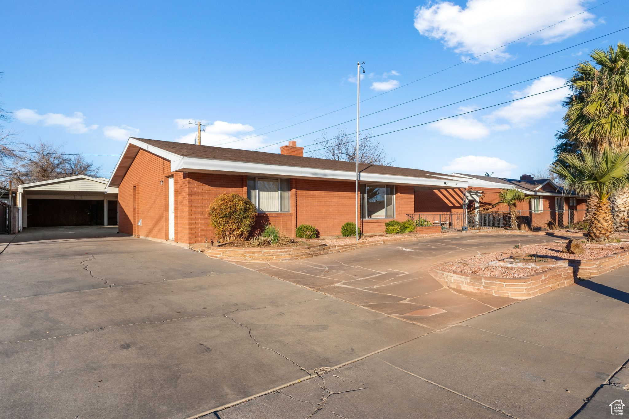 Charming 4-bedroom, 2.5-bath home in the heart of downtown St. George! Walking Distance to University. This spacious home is ready for your personal touch, featuring a large formal living room, open-concept family room and kitchen, and an oversized office with its own private entrance. Storage abounds throughout the home, and the detached 660 sq. ft. 2-car garage offers additional space for vehicles, tools, or hobbies.  The backyard is a gardener's delight with a greenhouse, grapevines, and a designated garden area, plus a large concrete patio and seating area for outdoor enjoyment. Energy efficiency is a bonus with a geothermal heating and cooling system, helping you save on utility costs.  Located close to Dixie State University, schools, the hospital, parks, dining, and shopping, this home combines convenience and potential in a prime location. Don't miss this opportunity-schedule a showing today!