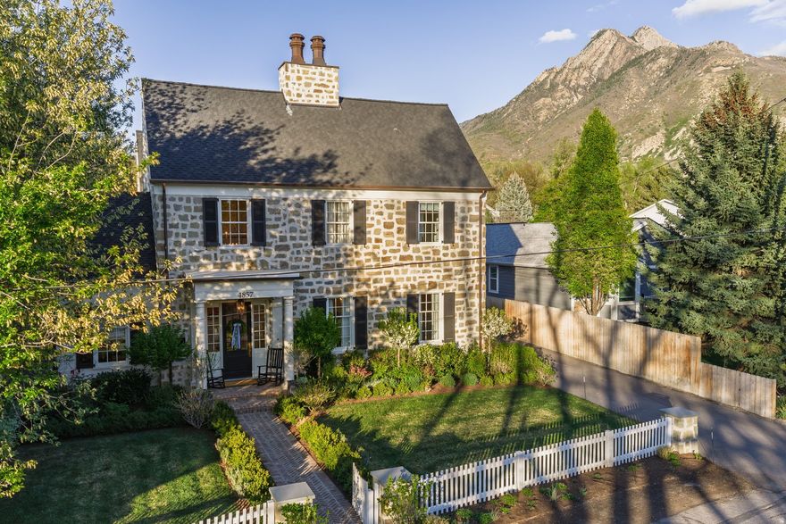 As seen in Architectural Digest and Cottages & Bungalows, this Fox Groupdesigned residence is a home that quietly captivates-where every detail has been considered and every space tells a story.  From the moment you arrive, the sandstone exterior, graceful columns, and welcoming front porch set a tone of timeless elegance. Copper accents catch the light, while mature landscaping and thoughtfully designed grounds create a sense of privacy and calm. A charming pathway leads to a secluded courtyard with a glowing outdoor fireplace-perfect for slow evenings and intimate gatherings-while the backyard unfolds into a lush, garden-like retreat made for both entertaining and everyday living.  Inside, the home is warm, layered, and effortlessly functional. The kitchen serves as the heart of the home, with rich cabinetry, intricate millwork, warm wood tones, and a statement backsplash that anchors the space. The butler's pantry offers both beauty and utility, ideal for hosting or keeping daily life beautifully organized. Throughout the home, custom built-ins add character and purpose.  A soft, cohesive palette paired with timeless finishes-brass hardware, custom moldings, and curated lighting-creates a sense of quiet luxury and continuity from room to room.  This is more than a home-it's a rare opportunity to own a nationally recognized property where architectural charm and modern living come together in a way that feels both elevated and deeply personal.