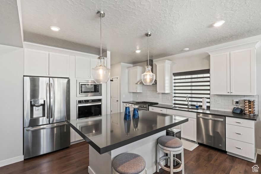 Say Hello to a home that's designed for living, gathering, and making memories. The moment you walk in, you'll be greeted by a bright, open great room that flows right into the kitchen and dining space. And yes, the oversized island is just waiting for pancake mornings, homework sessions, or late-night snacks. Head upstairs and you'll find four cozy bedrooms, a full bath, and the laundry room right where you need it (no hauling baskets up and down the stairs!). The star of the show is the spacious primary suite, complete with dual sinks, a walk-in closet big enough to actually use, and a spa-style shower made for unwinding. Outside, you've got curb appeal with partial Hardie Board and stucco, plus a fully landscaped, fenced-in corner lot-perfect for pets, BBQs, or just kicking back. And since the home is energy-efficient, it's not only stylish but smart too.