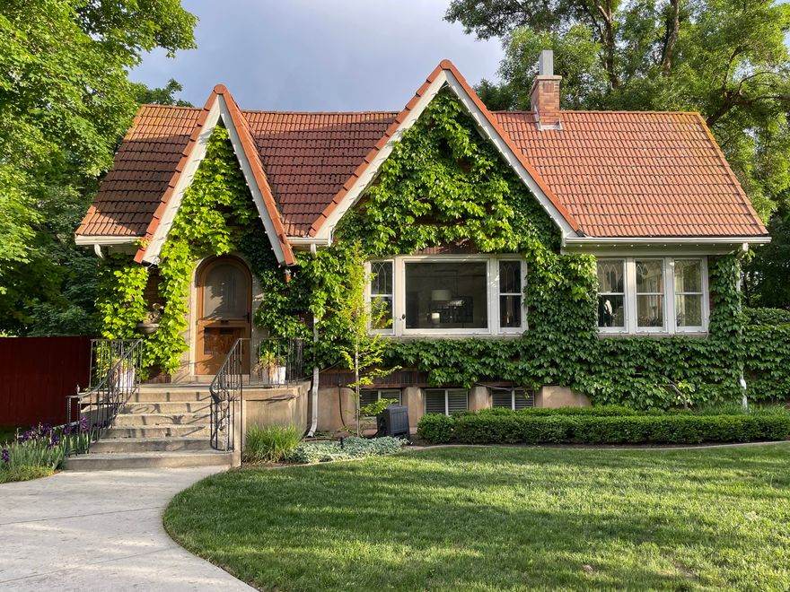 A Rare Sugarhouse Tudor - Where 1930 Never Looked So Timeless. Some homes simply stop you. This storybook 1930 Tudor in one of Salt Lake's most coveted neighborhoods is one of them - 2,630 square feet of craftsmanship, character, and soul that modern construction simply cannot replicate. Beneath your feet, tiger oak hardwood floors tell the story - a species so prized it's no longer commercially available. Original windows frame the world like paintings. Every detail speaks of a time when homes were built with intention and artistry. The finished basement surprises with above-average ceiling heights, rare for homes of this era, offering true livable space that feels anything but below grade. The oversized 0.27-acre lot includes a 2-car garage accessed from the side street - no backing onto busy traffic, just effortless ease. And then there's the garden. Behind a commanding 7-foot stone wall, a private English sanctuary awaits - corner fountain, lush plantings, and a silence so complete you'll forget the city exists. 4 bedrooms. 2 bathrooms. 2,630 sq ft. A garden that will make your soul exhale. Sugarhouse at its absolute finest.