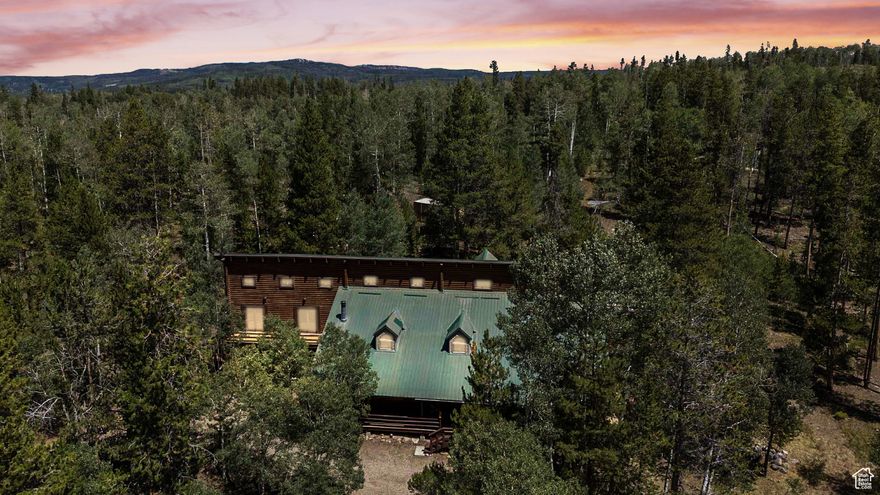 Welcome to your dream cabin nestled in the beautiful Manor Lands gated community, near the picturesque Christmas Meadows of the Uinta Mountains. This spacious yet cozy retreat is ideal for bringing together family, friends, or coworkers - whether you're planning a large reunion, a holiday getaway, or a quiet weekend escape. Designed with connection and comfort in mind, the cabin features a game room, a generously sized kitchen, and a large family room where everyone can gather and make lasting memories. Most bedrooms offer walkout access to private decks, creating the perfect spot to relax, breathe in the fresh mountain air, and take in the peaceful surroundings. A few of the bedrooms are charming loft spaces, accessed through other rooms, making them perfect for kids or those seeking a bit of adventure and charm. This cabin has been the backdrop for countless summers, Christmases, and weekend getaways. It's ready to become the heart of a new family's memories. In the winter months, access is part of the adventure - just a short snowmobile, ski, or snowshoe trip from the winter parking area, located a quick hop, skip, and a jump down the road. Don't miss this rare opportunity to own a legacy property where memories are made, season after season.
