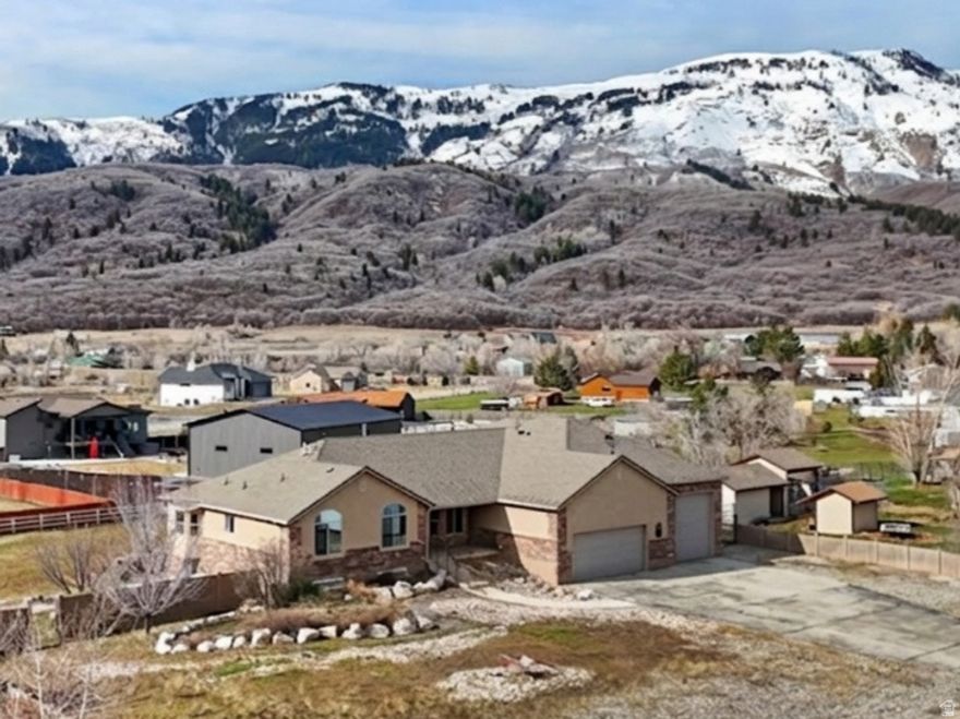 Located in Liberty, Utah, this property puts you at the doorstep of Pineview Reservoir and some of the most sought-after ski resorts in the state, all while sitting on a private, HOA-free lot with mountain views that are genuinely hard to beat. This is the kind of location that draws people to Utah in the first place - and this home delivers.  Inside, the fully remodeled chef's kitchen is built for real use - a built-in refrigerator, double ovens, a 5-burner gas range, and a walk-in pantry with a dedicated Costco door that makes stocking up effortless. The open floor plan keeps the kitchen connected to the main living areas, making it easy to host. The primary suite is a standout, with double sinks, a steam shower with dual showerheads, and a jetted tub - the kind of setup you'd expect in a high-end resort, not a primary home.  A large flex room with 270 wraparound mountain views offers endless possibilities - home office, gym, studio, or simply the best seat in the house.  The basement is its own destination. Radiant heated floors run throughout, a wet bar anchors a fantastic hangout space built for game nights and gatherings, and a dedicated theatre room gives everyone a place to unwind.   Then there's the garage. A 5-car heated garage with RV parking up to 54 feet long, a built-in EV charger, and a solar system to offset the energy costs - this setup is as practical as it is impressive. Whether you're storing snowmobiles, boats, ski gear, a full-size RV, or plugging in an electric vehicle, everything has a place. And with no HOA, there are no restrictions on how you use any of it.  Liberty is a tight-knit community with quick access to everything the area offers - powder days at Powder Mountain, Snowbasin, and Nordic Valley, summer days on Pineview, and trails year-round.