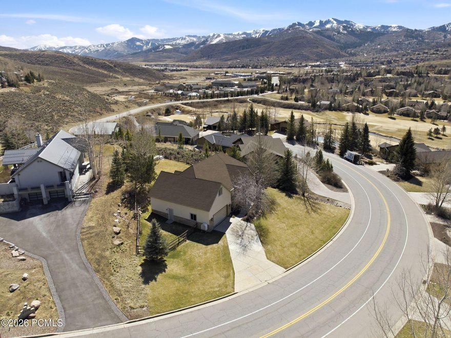 Unobstructed views of Deer Valley and Park City Mountain highlight this beautifully maintained 6-bedroom, 4-bathroom home in the desirable Jeremy Ranch community within the Park City School District. Offering approximately 4,300 square feet, a 3-car tandem garage, central air conditioning, and an open main-level floor plan, this home combines spacious mountain living with thoughtful upgrades throughout. Built in 2005 and primarily used as a second home, the property has been exceptionally well cared for.  The open main level is designed for gathering, with hardwood floors in the kitchen, dining, and great room, granite kitchen countertops, and tall or vaulted ceilings that create a bright and welcoming space. Large windows frame the surrounding mountain scenery and bring natural light throughout the home.  The main level includes the primary suite with an en suite bathroom and direct access to the patio, along with two additional bedrooms and a full guest bathroom. The lower level offers three additional bedrooms, including two en suite bathrooms, plus a spacious family room with a built-in entertainment center and abundant natural light. Generous storage is found throughout the home, including in the finished attic and loft areas.  Outdoor living is a highlight. The gated backyard features a large deck and hot tub, perfect for entertaining or relaxing after a day on the slopes. An upper patio provides a peaceful spot for morning coffee or evening cocktails while taking in the mountain views.  Jeremy Ranch offers a strong sense of community with convenient access to ski resorts, hiking and biking trails, Jeremy Ranch Golf Course, shopping, and dining. Located approximately 15 minutes from Historic Main Street Park City and about 25 minutes to Salt Lake City International Airport, the home offers easy access to both town and travel.  Buyer to verify square footage and all information to their satisfaction.