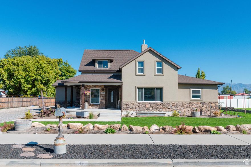 Owned and loved by one family for nearly a century, this farmhouse in the heart of Payson is the property you've been waiting for! Set on 1.81 acres, this 3-bedroom, 1-office, 2-bath home blends historic charm with thoughtful modern updates.    The grand kitchen offers ample space to cook & entertain- complete with butler's pantry, and wood-burning stove (also piped to second level of the home). And don't miss the cozy office, spacious laundry, and full bath right off the kitchen.  The inviting wrap-around porch sets the warm welcoming tone of the home, complete with light-sensing lights and permanent Illuminate Outdoor Lighting for every season.  Upgrades done in the past decade: expanding the kitchen and primary bedroom/bath, adding back patio/carport, new roof, furnace, air conditioner, water heater, flooring, plumbing, electrical, triple-pane windows, and attic insulation. The covered back patio spans the full length of the home. Built with steel-coated I-beams and posts to withstand the heaviest snow, the space is perfect for year-round entertaining, soaking in the hot tub, and parking autos, ATVs and bikes.  The impressive 32' X 35' barn is perfect for storing vehicles, equipment, RV's, hay, and the open covered flex space serves for horse stalls or additional parking. Complete with running water, lighting and enough amps to operate a welder.  An additional 1200-square-foot shed is ideal for hobbies and more storage (stubbed for power).   The property is approved for two horses and other animals. Gravel was recently brought in to cover the back lot for parking semi's and heavy equipment, but could be cleared and converted to corrals and other ag needs.   There are two RV power hook-ups as well as an on-site sewer dump.   Schedule your private tour of this one-of-a-kind homestead today or join us at the open house Saturday from 11am to 1:00 pm.  *Home square footage measurements taken from recent appraisal.*