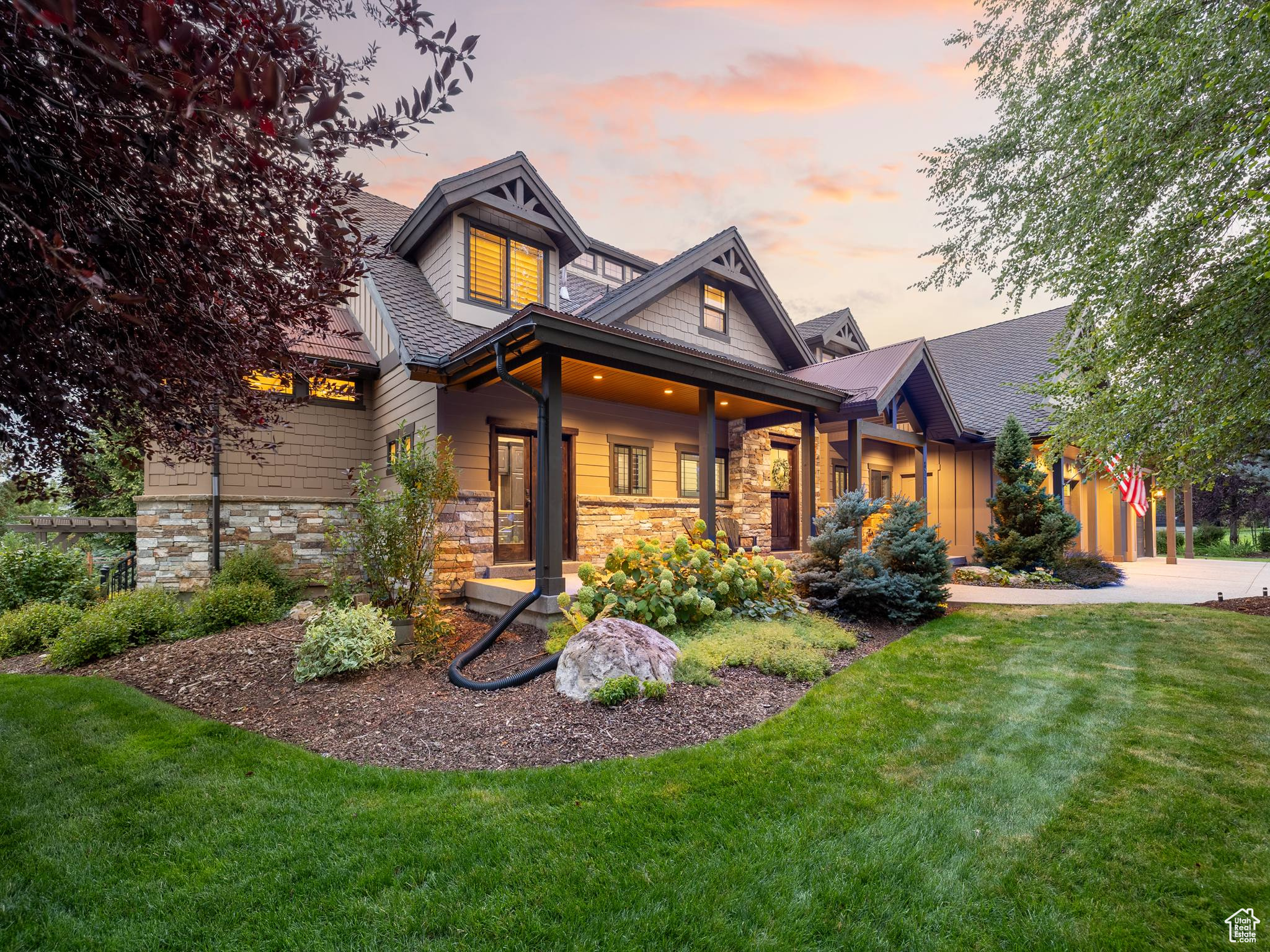 Designed and built by well-known luxury home builder Samson McGinnis as his own residence, this custom-crafted home showcases the artistry and detail he is known for in Park City's most stunning mountain settings. Every detail has been thoughtfully designed, blending timeless architecture with modern comfort in a serene, wooded cul-de-sac setting. Inside, the heart of the home is anchored by a dramatic double-sided natural stone fireplace that warms both the living and dining areas. The peaceful living room rests beneath soaring vaulted ceilings, with expansive panoramic windows that frame views of mature trees and fill the interior with light, while indirect skylights add a soft glow throughout. Custom finishes abound, from board-and-batten detail and iron stair rails to the home's striking architectural lines that carry seamlessly from the interior to the exterior. Your gourmet kitchen is a chef's dream, featuring a Viking refrigerator, and high-end appliances like the oversized commercial six-burner gas range with griddle, commercial hood, double ovens, a built-in ice maker, dishwasher, and a farm-style stainless basin sink, along with a central island for prep and serving. Just off the kitchen, the dining room flows easily for gatherings and opens to a private covered deck, creating an ideal indooroutdoor living space. Main-level living makes life simple with the owner's suite, kitchen, laundry, and a private office all on the main floor. The owner's suite includes a freestanding soaking tub, a modern walk-in shower, dual sinks, a large walk-in closet, and private deck access. Every bedroom in the home features a walk-in closet, providing ample storage and comfort. Downstairs, the daylight walkout basement offers bright, open living with a large creative studio/craft room, a theater with wet bar and fridge, a playful nook under the stairs, and a warm, radiant-heated, stained concrete floor. Thoughtful details include lightwell windows with lush greenery and a walkout to a quiet sunken patio that is surrounded by beautiful plantings creating a tranquil garden escape. Outdoor living is seamless with multiple covered decks and patios, including the sunken patio framed by vibrant plantings that offer a tranquil, private escape, a private covered dining area, a covered deck connecting the living room and owner's suite, and a generous front porch with direct access into the foyer, garage, and office. The yard is a secluded haven with lush mature landscaping, a fenced garden, and the natural beauty of deer and wildlife passing through. Additional highlights include a three-car garage with a tandem bay that provides space for a fourth vehicle or RV storage, along with an EV-ready 220 outlet, abundant storage throughout the home, whole-house in ceiling audio, and a custom shed designed to match the residence-all set on one of the community's most peaceful lots. The Dutch Fields community offers a lifestyle as enriching as the home itself, with a swimming pool, playgrounds, tennis and sports courts, a clubhouse, and quiet walking paths past ponds and seasonal streams. Large open spaces and grass play fields make this a truly unique neighborhood where nature and the friendly community come together. This remarkable luxury home is just 10 minutes from the Jordanelle Gondola and Deer Valley East Village, 20 minutes to Park City, and 40 minutes to Salt Lake City International Airport-making it the perfect blend of seclusion, community, and access. Just beyond your doorstep, enjoy fly fishing in the Provo River, Dutch Hollow hiking and mountain biking trails, and year-round recreation in Wasatch Mountain State Park-including camping, golf, horseback riding, cross-country skiing and snowshoeing, and ATV/snowmobile trails. Schedule your private tour today and experience a home where luxury meets nature.