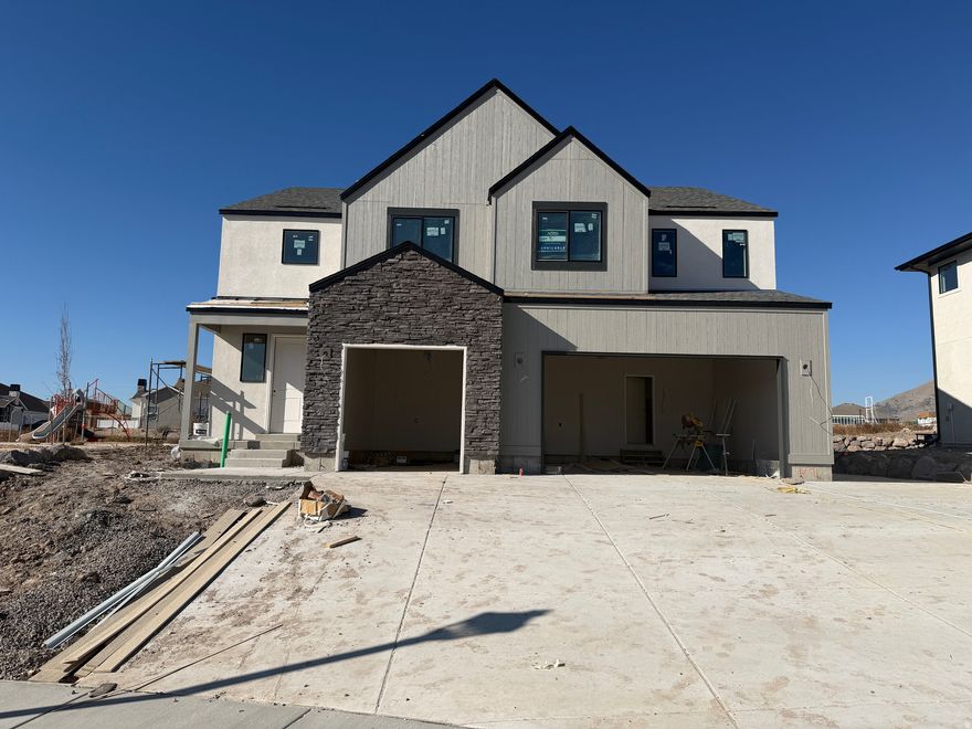 Come visit this home today located in the beautiful Dignity Subdivision in northern Saratoga Springs. This cul-de-sac community provides 10 new home sites with gorgeous views of the mountains and lake. This home has a fabulous incentive! $25,000 when using the listed lender, or $23,000 when using outside lender, funds can be used towards closing costs and interest rate buy-downs. The Oak is a fantastic two-story plan with an array of impressive features! The home is fully upgraded with gorgeous interior selections and a finished two bedroom ADU in the basement! The spacious primary suite offers a private retreat with a large bathroom, separate tub and shower that has a clean euro glass surround. On the main floor, a guest bedroom with a full bath provides comfort and privacy for visitors. Upstairs, you'll find four additional bedrooms and a versatile loft area, perfect for relaxation or work. Enjoy outdoor living on the covered patio and benefit from the convenience of a three-car garage and RV parking with a concrete path to the basement entrance.