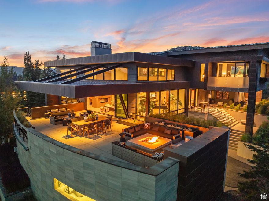 Full Golf Membership Available! Nestled against the breathtaking Wasatch Mountain Range, this masterpiece by award-winning architect Clive Bridgwater redefines luxury living with unmatched panoramic views and seamless indoor-outdoor entertaining spaces. This 5-bedroom estate boasts 1,700 square feet of unrivaled outdoor living, featuring multiple fireplaces, elegant seating arrangements, a meticulously landscaped enclosed backyard perfect for dogs, a private putting green, and a front deck showcasing stunning mountain vistas and sunsets. Inside, a chef's kitchen flows effortlessly into a bar area and great room, crowned by soaring two-story ceilings, a double sided fireplace, creating an open and inviting atmosphere ideal for hosting. The expansive 1,500-square-foot primary suite offers a luxurious private sanctuary with a spa-like bathroom.  Custom finishes, bespoke light fixtures, and strategically placed lighting highlight the home's meticulous craftsmanship. Complete with an 8-car garage, this architectural gem blends functionality with elegance, offering a rare opportunity to own a home where every detail reflects Bridgwater's visionary design, perfect for those who value sophistication and design.