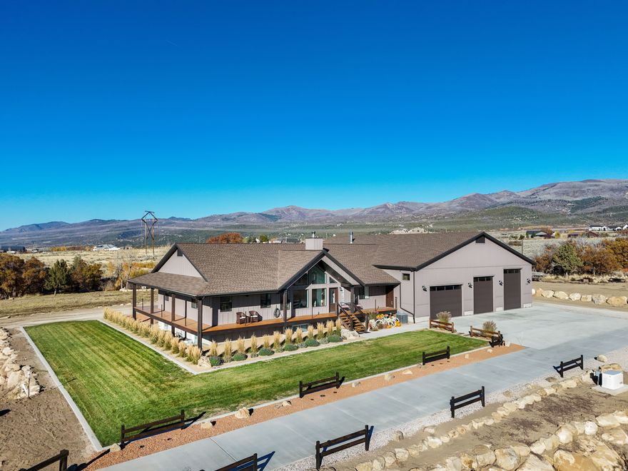 Private Mountain Estate on 5.2 Acres | 10-Car Garage | Luxury, Space, and Self-Reliant Living |  Hidden among the beauty of Utah's mountain landscape sits a truly rare opportunity to own a private custom estate designed for those who value freedom, space, and possibility. Situated on 5.2 secluded acres with a seasonal stream, this one-of-a-kind property offers breathtaking views, peaceful wildlife, and the ability to create a lifestyle few homes can provide.  As you arrive, a stunning concrete driveway crosses a charming bridge, welcoming you into a setting that feels worlds away from the everyday. The property unfolds into wide open space, towering skies, and the quiet serenity of nature.  The centerpiece of this remarkable estate is the impressive 4,400+ sq ft garage and workshop with room for up to 10 vehicles. Thoughtfully designed with a loft, kitchenette, washer and dryer hookups, gym, RV hookups, and a 3/4 bathroom, this extraordinary space opens the door to endless possibilities. Whether you are a collector, automotive enthusiast, entrepreneur, creative builder, or someone who loves to host large gatherings, retreats, or masterminds, this space transforms imagination into reality.  Inside the home, the open-concept living and kitchen area captures sweeping views through large windows on both the north and south sides, bringing the outside in and creating a warm, inviting environment for entertaining or relaxing as deer quietly pass through the property.  Encircling the home is a magnificent heavy timber wrap-around porch with deep overhangs, offering multiple outdoor living areas to enjoy morning sunrises, peaceful evenings, and star-filled mountain skies. The space easily accommodates outdoor seating, dining, or even a future hot tub overlooking the landscape.  The luxurious primary suite provides a private retreat with a sitting area, walk-in closet, spa-inspired soaking tub, and beautiful walk-in shower.  The fully finished basement offers exceptional flexibility with a spacious family room, two large bedrooms, space for an additional bedroom, and four generous storage rooms. A thoughtfully designed mechanical room adds efficiency and accessibility to the home's infrastructure.  Additional highlights include:   Pole barn for equipment, firewood, RVs, or recreational vehicles  Three RV hookups ideal for guests or additional use  Permanent exterior lighting   Accessibility considerations incorporated into the home's design  This estate was created for those who dream bigger - those who want room to build, create, host, and live life on their own terms. Whether you envision a private retreat, collector's compound, apocalypse preparer, hobbyist haven, or a gathering place for unforgettable events, this property delivers unmatched versatility in a breathtaking setting.  Rarely does a property combine acreage, views, massive garage space, and custom living in such a compelling way.  Private showings available with proof of funds or pre-approval.  Square footage figures are provided as a courtesy estimate only and were obtained from blueprints. Buyer is advised to obtain an independent measurement. Information deemed reliable but not guaranteed; buyer and buyer agent to verify all information.