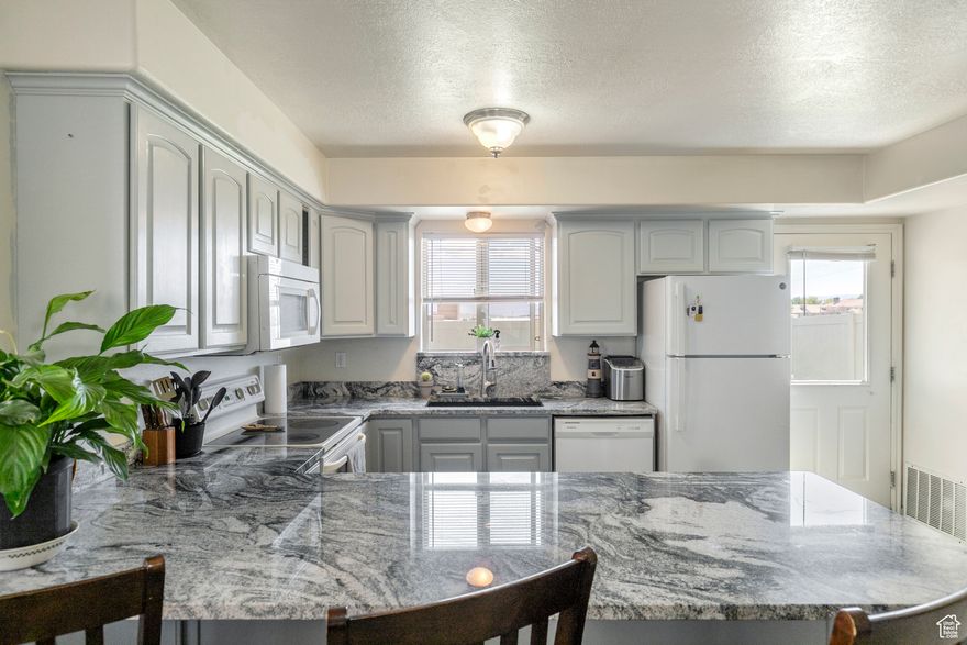 MOTIVATED SELLER!!! Tucked away in a quiet community just a short walk from Costco, this beautifully maintained end-unit townhome offers the perfect blend of comfort, convenience, and value. Inside, you'll find a bright and airy layout with 3 bedrooms, 2.5 bathrooms, and over 1,350 square feet of well-designed living space. Step into the remodeled kitchen, featuring modern finishes, updated cabinetry, and plenty of natural light that flows throughout the home. The fenced backyard is perfect for pets, play, or relaxing evenings-with no rear neighbors for added privacy. The HOA takes care of front and back landscaping, exterior insurance and maintenance, as well as upkeep of the park area and private road-all with low monthly dues. You'll also love the added privacy and natural light that comes with being an end unit. Located just minutes from shopping, dining, and quick I-15 access, this home is ideal as a first-time purchase, investment property, or low-maintenance retreat. Come see why this gem is more than just a home-it's a smart move