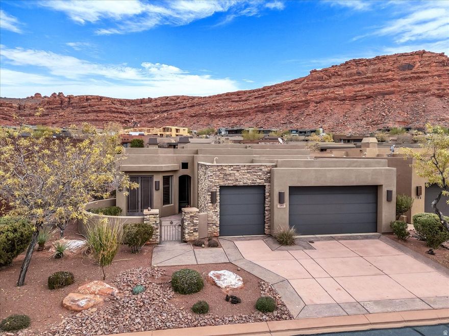 Set within one of Southern Utah's most prestigious gated golf course communities, Entrada at Snow Canyon. Surrounded by dramatic red rock landscapes and sweeping mountain views, the home blends timeless Southwestern architecture with elegant modern finishes. The open concept design is ideal for both everyday comfort and entertaining, featuring soaring ceilings, custom cabinetry, stone accents and expansive windows that invite natural light. The gourmet kitchen anchors the living space with generous counter space, high end appliances and a large island. The living room features a striking stone fireplace and ample room for entertaining. Outdoor living is equally impressive with a beautifully landscaped backyard, large patio, private courtyard to relax and enjoy the desert surroundings.  Enjoy world glass golfing, access to Snow Canyon State Park, Black Desert as well as resort style HOA amenities that includes clubhouse, pool, fitness center, and pickleball courts. This exceptional home offers a rare opportunity to experience luxury living, privacy and breathtaking desert surroundings in on of the Southern Utah's most desirable communities.