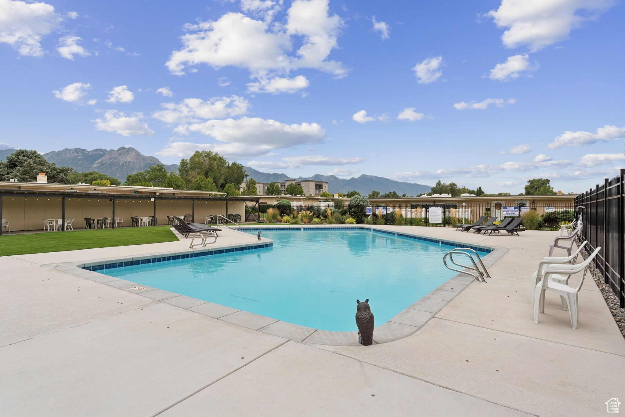 Welcome to Capri Village, a hidden gem nestled in the heart of Millcreek. This charming subdivision offers a unique blend of suburban tranquility and urban convenience, making it a perfect place to call home.This highly sought-after 55+ community offers comfortable, low-maintenance living. Along with a pool and clubhouse to enjoy, the community is well-maintained and includes snow removal. Completed in 2021, this is a modern, single-level condo that features a bright, open floor plan. The kitchen has beautiful white quartz countertops with plenty of surface area for cooking. The counter height and a counter top microwave oven were installed with wheelchair accessibility in mind. Head outside through the sliding glass doors and you will discover a quiet, fenced patio to relax and enjoy the fresh air. The bedrooms are both roomy and flexible. Two bathrooms, one with a bath and the other with a walk-in shower, allow privacy for everyone. A dedicated and covered parking space is only a few steps from the front-door; this makes bringing in the groceries a breeze. Don't wait, come see how fabulous a mature neighborhood with contemporary living can be! Square footage figures are provided as a courtesy estimate only and were obtained from plat map and tax records. Buyer is advised to obtain an independent measurement.