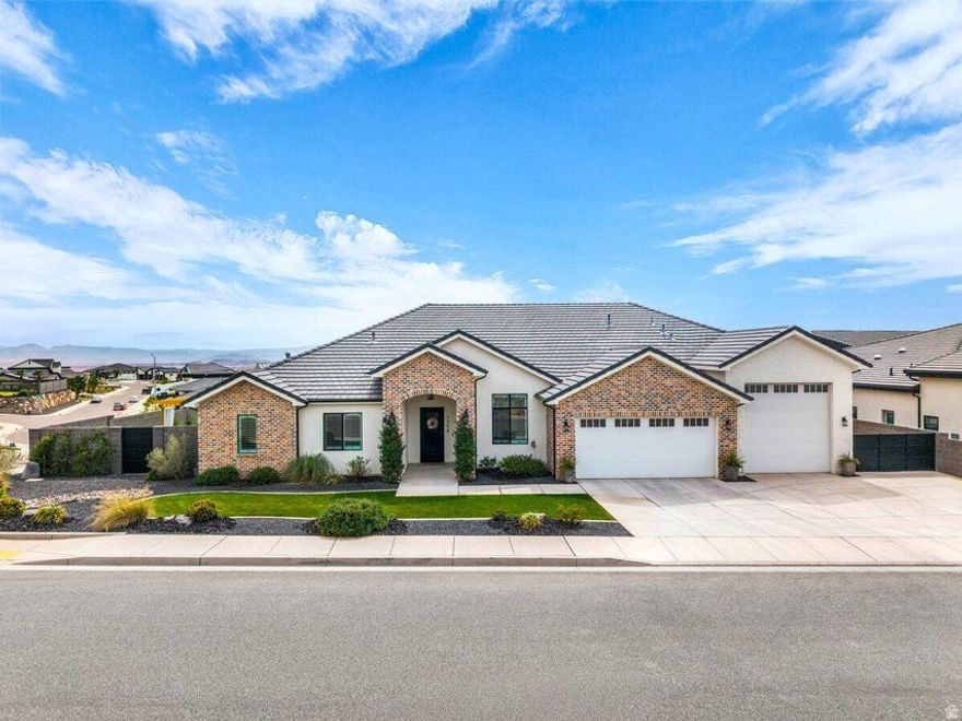 Experience elevated Southern Utah living in this custom owner-built home with NO HOA, thoughtfully designed with high-end upgrades throughout. Take in breathtaking panoramic views of the city and surrounding mountains from a property that truly captures the beauty of the area. The backyard is an entertainer's dream featuring a massive, covered patio, outdoor TV, firepit, fireplace, and a fully equipped outdoor kitchen with a built-in pizza oven! Inside, the home shines with a huge kitchen island, commercial-sized fridge and freezer, pot filler, induction cooktop, premium quartz, and a spacious butler's pantry with leathered granite and a barn sink. A stackable, accordion sliding glass wall creates seamless indoor-outdoor living, perfect for gatherings year-round. The oversized primary suite offers two private entrances from outside, a spa-ready setup, and a massive walk-in closet complete with laundry hookups. Additional highlights include designer-grade carpet, floor-to-ceiling tile, stacked stone accent walls, and a large laundry room. The impressive 44' RV garage features a 12x12 door, 16' interior width, and extra storage space to accommodate all your toys. With the community backing to BLM land, enjoy direct access to endless trails, perfect for biking, ATVs, and outdoor adventure right from your doorstep! Buyer to verify all information, deemed reliable, however, buyer to verify all info including utilities, rental restrictions, and ACC information if applicable.