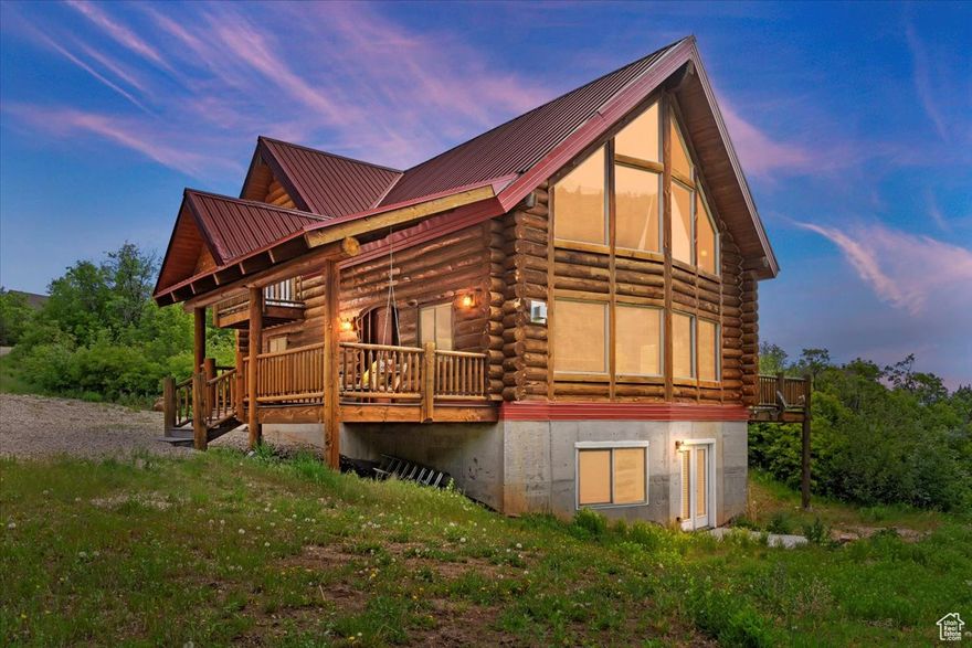 PROPERTY RECENTLY APPRAISED AT  $900,000!  Staying in Oak Haven, you'll experience the perfect blend of rustic charm and modern luxury in this stunning log cabin, crafted with 12" logs for a true mountain retreat feel. Boasting double ovens, custom cabinetry, granite countertops, and rock-tiled showers on all three levels, this home is designed for comfort and elegance. Massive windows frame breathtaking mountain views, showcasing nature's beauty through every season-from vibrant fall foliage to snow-capped peaks and lush spring greens.  Step onto the expansive front and back decks, perfect for entertaining guests or simply unwinding on the porch swing while soaking in the serene surroundings. Enjoy year-round living with 18 water shares, a 2000-gallon propane tank, and a septic system with two new pumps. With 5 bedrooms, 3 baths, 2 spacious living areas, and a loft office, there's ample space for relaxing and entertaining.  Nestled just minutes from the charming town of Midway, this home offers easy access to five premier golf courses, the Jordanelle and Deer Creek reservoirs, and the world-class ski slopes of Deer Valley East Village. Outdoor enthusiasts will love the abundance of hiking, biking, and snowmobiling trails, making this a true year-round paradise. Whether you're escaping for a serene getaway or settling in full-time, this cabin is the ultimate mountain sanctuary. Square footage is provided as a courtesy estimate-buyers are encouraged to verify independently.