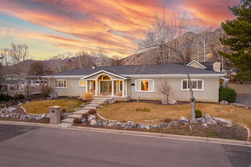 Two Homes on One Lot: A truly distinctive Indian Hills home. Set in one of Provo's most established and desirable neighborhoods, this exceptional property features a beautifully updated main residence plus a fully separate detached studio residence on the same lot. Originally built in 1967 and extensively remodeled in 2001, the main home combines timeless mid-century character with generous living spaces, vaulted ceilings, and impressive functionality. It's great for entertaining! Highlights include four main-level bedrooms, a large laundry room, multiple gathering areas, a large semi-formal dining room, oversized 2-car garage, and a chef's kitchen with granite countertops, cherry cabinetry, Sub-Zero refrigerator, gas range, warming oven, and abundant storage. The primary suite offers vaulted ceilings, dual closets, and a spacious bath with separate tub and shower.  The detached studio residence is a rare asset with remarkable flexibility (it's not an ADU). Originally created as the studio of renowned artist Greg Olsen, it includes its own basement, bath, fireplace, loft, separate HVAC, and exceptional natural light throughout. Loft area could function as a library, bedroom, storage, or flex space. The private, fully fenced yard, large flagstone patio, valley views, and stunning sunset setting complete the experience. Seller is offering a $20,000 allowance toward a new HVAC system for the main home. Art by current owner and local artist Val Boyes is displayed throughout and available for separate purchase.  Square footage figures are provided as a courtesy estimate only and were obtained from an Appraisal.  Buyer is advised to obtain an independent measurement.