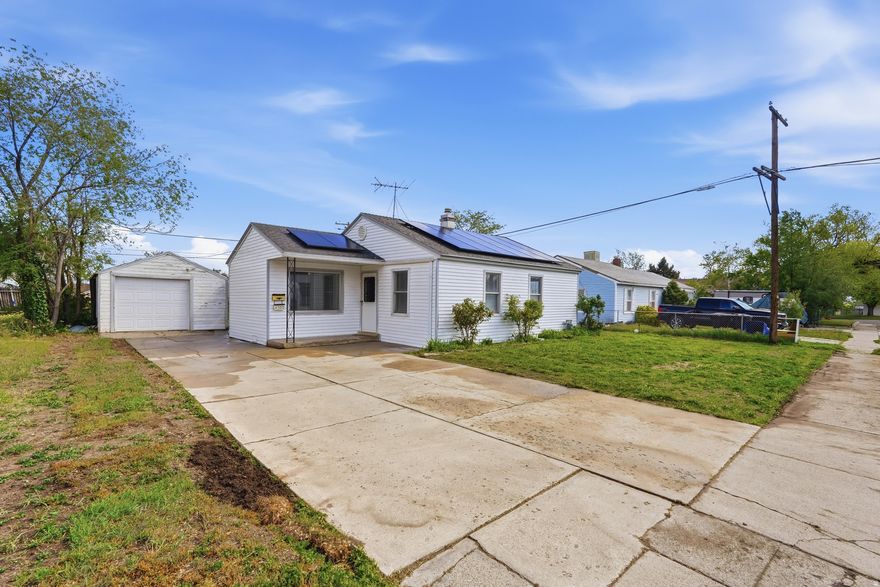 This cozy 2-bedroom, 1-bathroom single-family home in Kearns offers a fantastic entry point for a buyer looking to build equity and add their personal touch. The property features a functional single-car garage and a significant financial bonus: a solar panel system that will be fully paid for at closing, providing immediate energy savings. While the home is ready for some cosmetic updates, its solid bones and efficient layout make it a perfect canvas for a starter home or an investment property. The location is a major highlight, placing you within minutes of some of the area's most popular recreation spots. You are just a short drive from the Utah Olympic Oval, known as the Fastest Ice on Earth, where you can enjoy public ice skating, hockey, and high-performance sports. Right next door is the Kearns Oquirrh Park Fitness Center, a massive community hub with indoor and outdoor pools, a splash pad, and extensive fitness facilities. For outdoor enthusiasts, the nearby Lodestone Park offers modern playgrounds and walking paths, while the shopping and dining at Jordan Landing are only about 10 minutes away, making this a convenient and active place to call home. Figures are provided as a courtesy, buyer and buyers agent to verify all information.