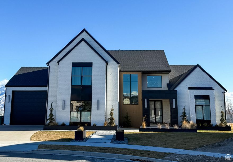 Step into refined elegance with this stunning custom-built home, perfectly situated on a spacious .71-acre lot with beautiful mountain views. Designed with care and built to the highest standards, this residence combines thoughtful craftsmanship, upscale finishes, and functional space to create a truly exceptional living experience.  Inside, you'll find a bright open-concept floor plan with soaring ceilings, laminate flooring, and designer lighting throughout. The gourmet kitchen features custom cabinetry, quartz countertops, high-end appliances, and massive double islands - the heart of the home and perfect for entertaining.  Relax in the inviting great room with large picture windows and a floor-to-ceiling fireplace, or retreat to the luxurious primary suite, complete with a spa-like ensuite bath, soaking tub, oversized walk-in shower, and dual vanities.  Downstairs, a spacious walkout basement offers endless potential. It's ideal for additional bedrooms, a home theater, gym, or even a full Accessory Dwelling Unit (ADU) with separate entrance - perfect for extended family, rental income, or a private guest suite.  Outside, enjoy the peace and privacy of a large yard, covered patio, and room to grow - whether you envision a pool, detached garage, or garden space.  With luxury upgrades throughout, room to expand, and jaw-dropping views, this home is a rare find that offers both comfort and long-term value.   Located just minutes from top schools, shopping, trails, and recreation - this is Utah living at its finest.  *Photos are of the same floor plan, but finishes may be different*