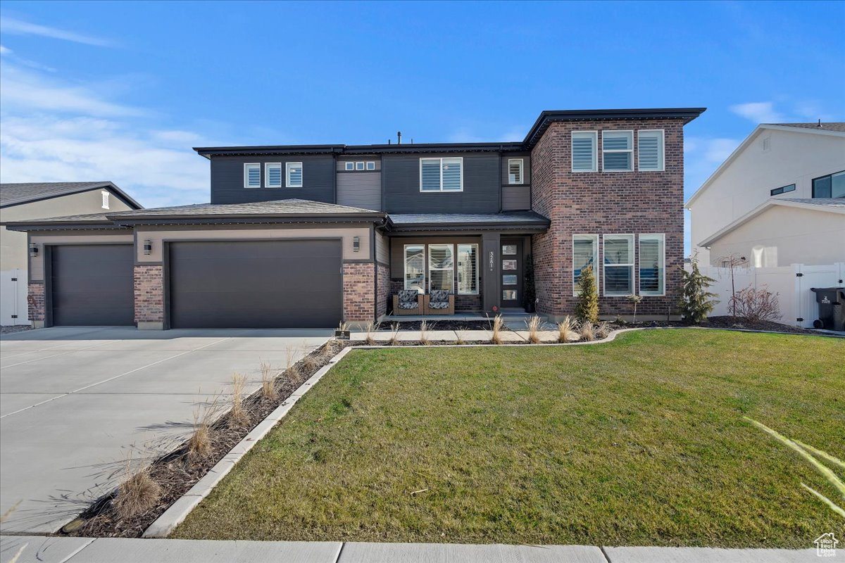 WOW is what you will say when you enter this home!  The wall of windows and massive 20ft ceiling let in so much natural light as well as a beautiful view of the mountains to the east.  The chef's kitchen is a dream come true with high end appliances and cabinets.  In addition, there is a butler's pantry for all your food prep and an awesome walk in pantry.  There is also a bedroom and full bath on main level.  Upstairs you will find a loft, office and/or bedroom, another bedroom, full bathroom, master suite with two walk in closets, and a laundry/craft room right out of a magazine!  The yard is fully fenced and finished which is a BIG bonus in a new home community.  The home also has permanent lights to give it ambiance and color for holidays and special occasions.  This two year old home still feels brand new but without the stress of putting in a yard, fence and window coverings.  West Davis Corridor SR177 exit is 3 minutes away with easy access to SLC.