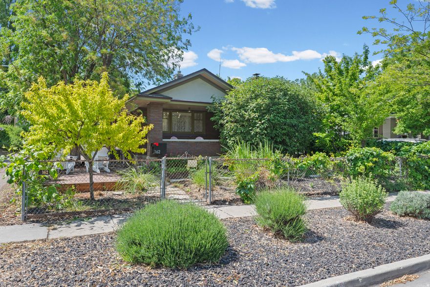Historic charm, thoughtful updates, and one of the city's most versatile detached studio spaces come together in this beautifully maintained bungalow in the heart of Salt Lake City. Set on a quiet, tree-lined street just minutes from Liberty Park, 9th & 9th, Central 9th, Ballpark, and some of the city's most beloved restaurants, cafs, breweries, and shops, this home offers exceptional walkability and an effortless urban lifestyle without sacrificing warmth or privacy. Inside, original wood floors, vintage built-ins with glass doors, and a professionally converted natural gas fireplace preserve the home's historic character while adding everyday comfort and ease. The open living and dining spaces feel both inviting and functional, with a generous foyer rarely found in homes of this era. The kitchen blends old and new with a six-burner Viking range, butcher block and granite countertops, original glass-front cabinetry, and a striking island topped with green-veined marble and crafted from an authentic Scandinavian farm table. The spacious primary bedroom opens directly onto a covered back deck through stained glass French doors, creating an easy indoor-outdoor flow. Downstairs, two additional bedrooms are accompanied by a generous laundry and storage area, with eco-friendly wool carpeting bringing warmth and softness to the lower level. Multiple outdoor living areas, including a covered back deck, courtyard firepit area, new hot tub, mature peach and plum trees, and a natural gas grill connection, create a private, retreat-like atmosphere ideal for entertaining or quiet evenings at home. Stay with me, because there's more! A standout feature of the property is the detached studio with cedar ceilings and skylights, offering incredible flexibility as an art or music studio, home office, fitness space, workshop, or creative retreat. The garage has also been thoughtfully arranged to function as either storage/workspace or vehicle parking. Major system updates include all new plumbing within the last five years, tankless water heater, updated HVAC, and newer roof. Full radon mitigation system has already been installed, along with a whole house water filtration system. For qualified buyers, the home also offers the rare opportunity to assume an existing VA loan with an interest rate below 3%. Check out the virtural tour, and then schedule a showing today!