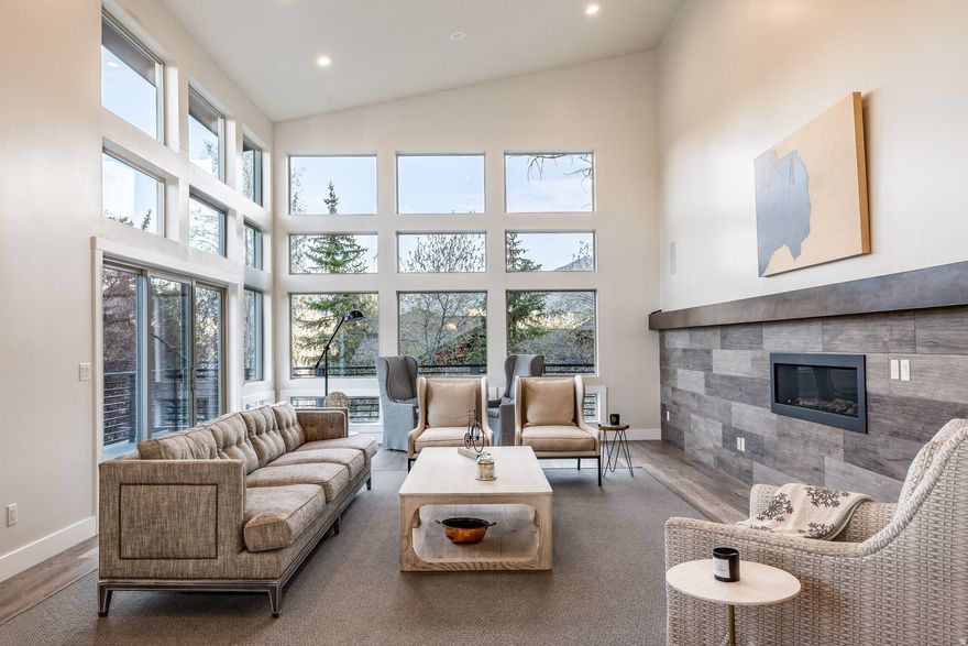 Experience effortless Park City living in this stylishly updated Park Meadows home with ski run views and exceptional indoor-outdoor flow. Designed for main-level living, the light-filled great room features soaring 14-foot ceilings and walls of glass that frame the mountains. The chef's kitchen, complete with Thermador appliances, double dishwashers, wine refrigeration, and a walk-in pantry, opens seamlessly to an inviting den and expansive deck, ideal for entertaining or quiet evenings under the stars. The main-level primary suite offers Deer Valley views, a fireplace, spa-like bath, and a generous closet with integrated workspace. Downstairs, four bedrooms, a wet bar, and gathering spaces create the perfect setting for hosting family and guests. Enjoy a beautifully landscaped, private yard with bocce court, firepit, and fenced dog run. Central air, a flat driveway, and an oversized 3-car garage complete this turnkey retreat just minutes from skiing, trails, and Historic Main Street.